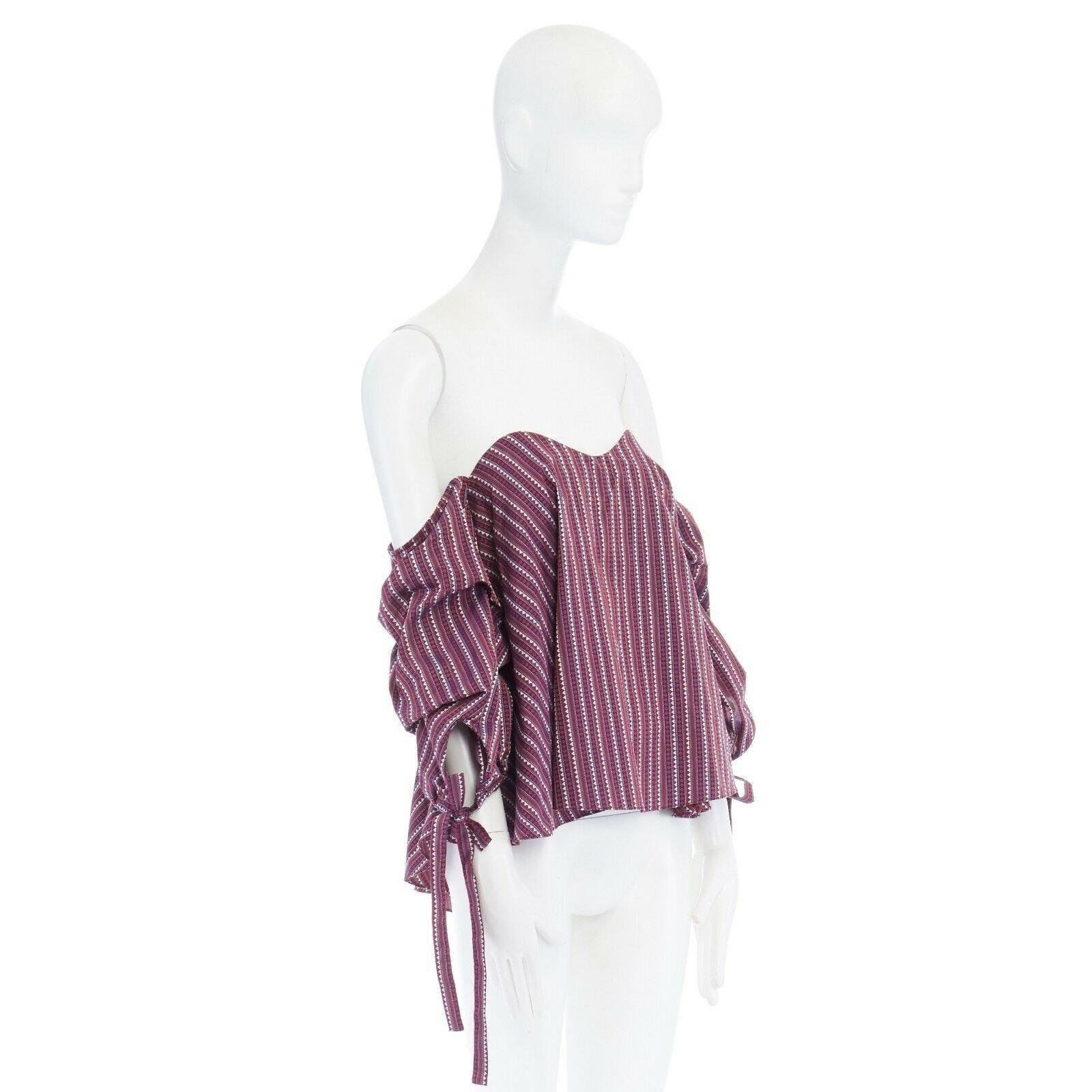 CAROLINE CONSTAS Gabriella purple ethnic jacquard off shoulder bustier top XS 
Reference: LNKO/A00403 
Brand: Caroline Constas 
Designer: Caroline Constas 
Material: Cotton 
Color: Red 
Pattern: Other 
Closure: Zip 
Extra Detail: Gabriella bustier