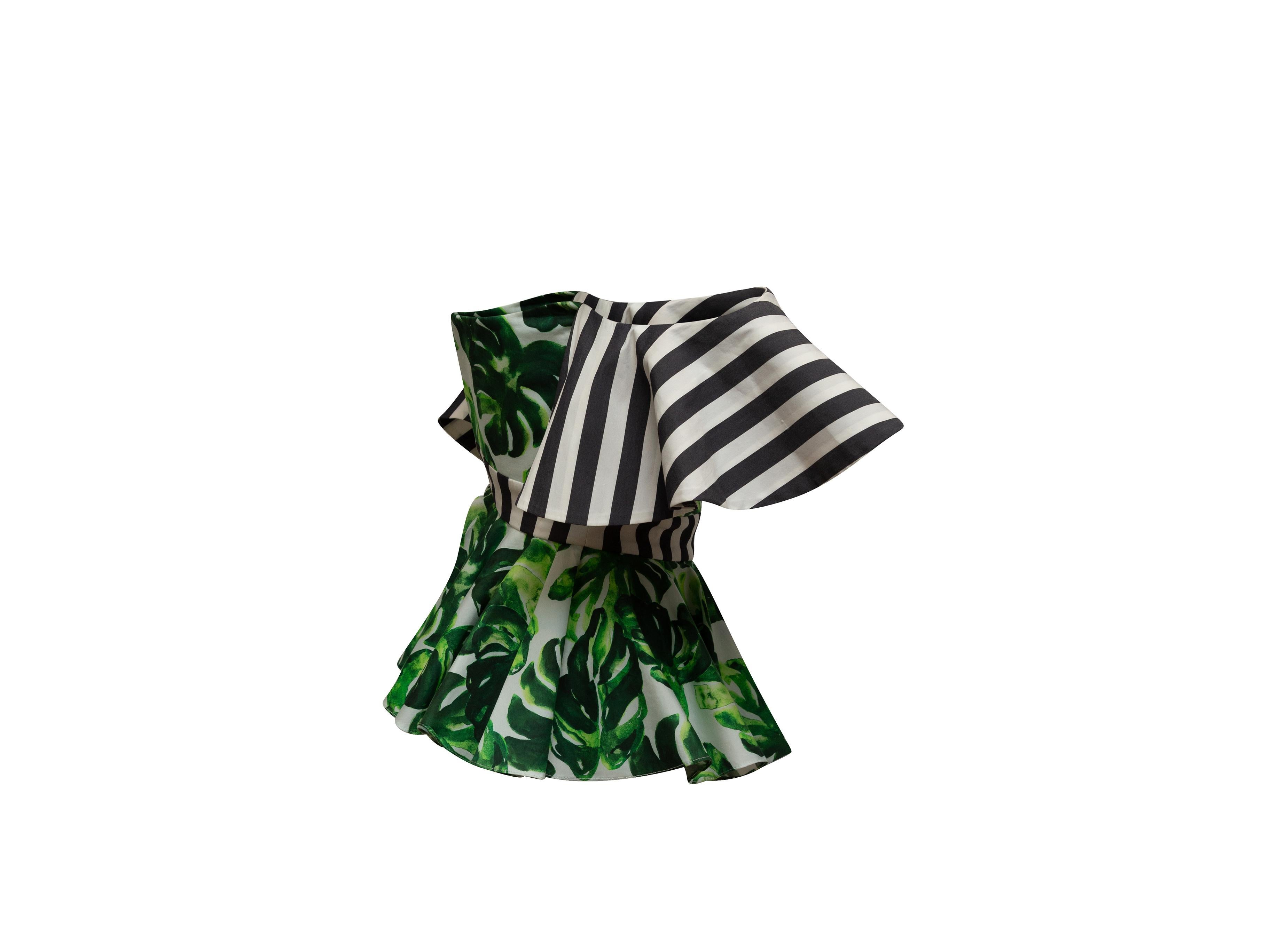 Product details: Green and multicolor off-the-shoulder top by Caroline Constas. Monstera leaf print throughout. Black and white striped trim. Sweetheart neckline. Zip closure at back. 28