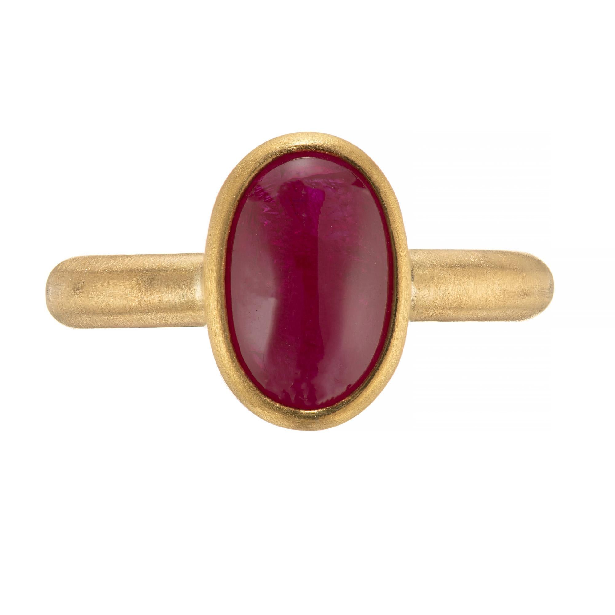 Caroline Ellen artistically styled ruby cabochon engagement ring. Oval bezel set oval ruby set in a classic brushed finish 20/22k yellow gold setting. 

1 oval cabochon red ruby, approx. 2.9cts
Size 7.5 and sizable
20/22k yellow gold 
Stamped: