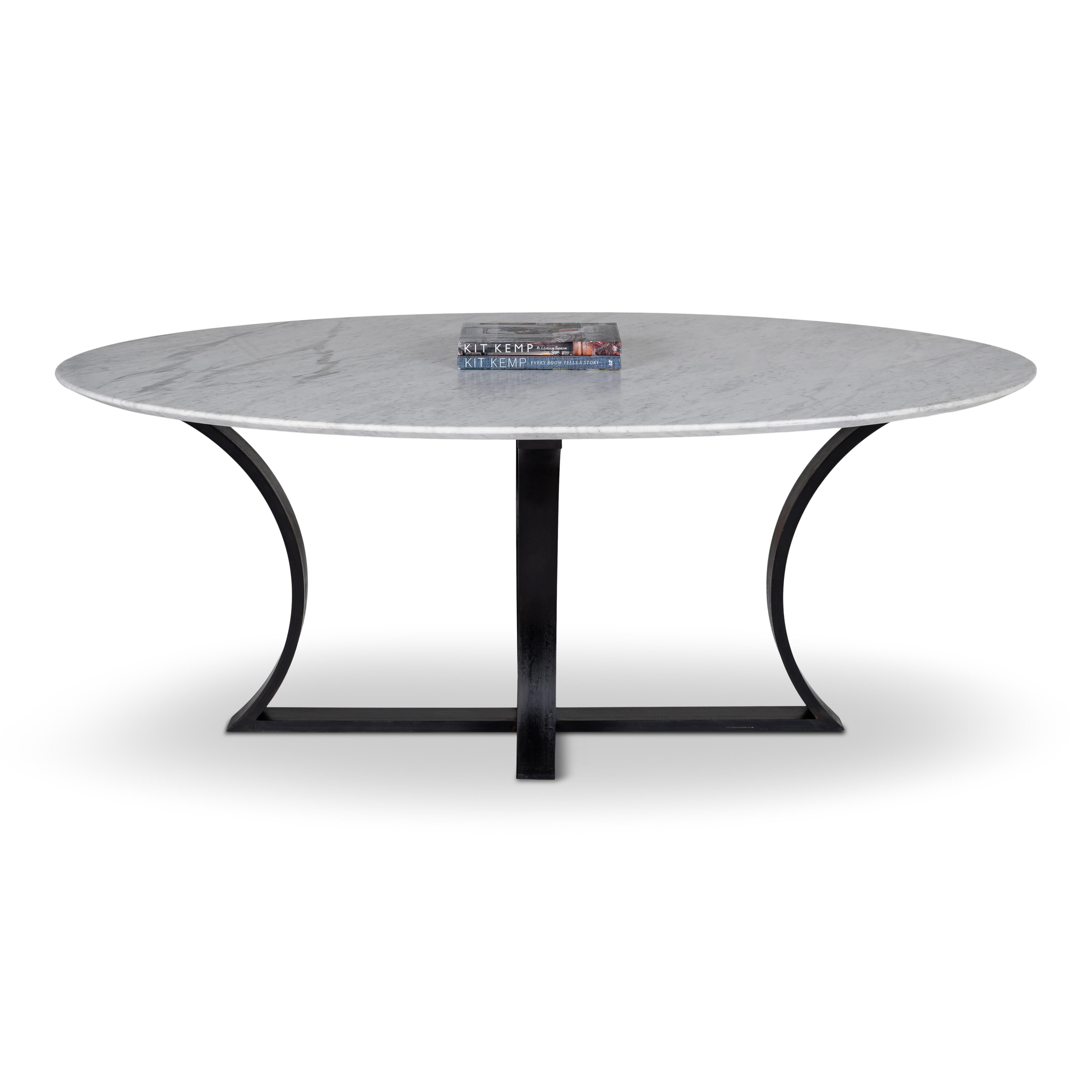 Honed carrera marble dining table on ebonized metal base.

This item is crafted from natural materials. Coloring and detailing may vary, adding to its uniqueness.

Designed by Brendan Bass for the Vision and Design Collection, by using high quality