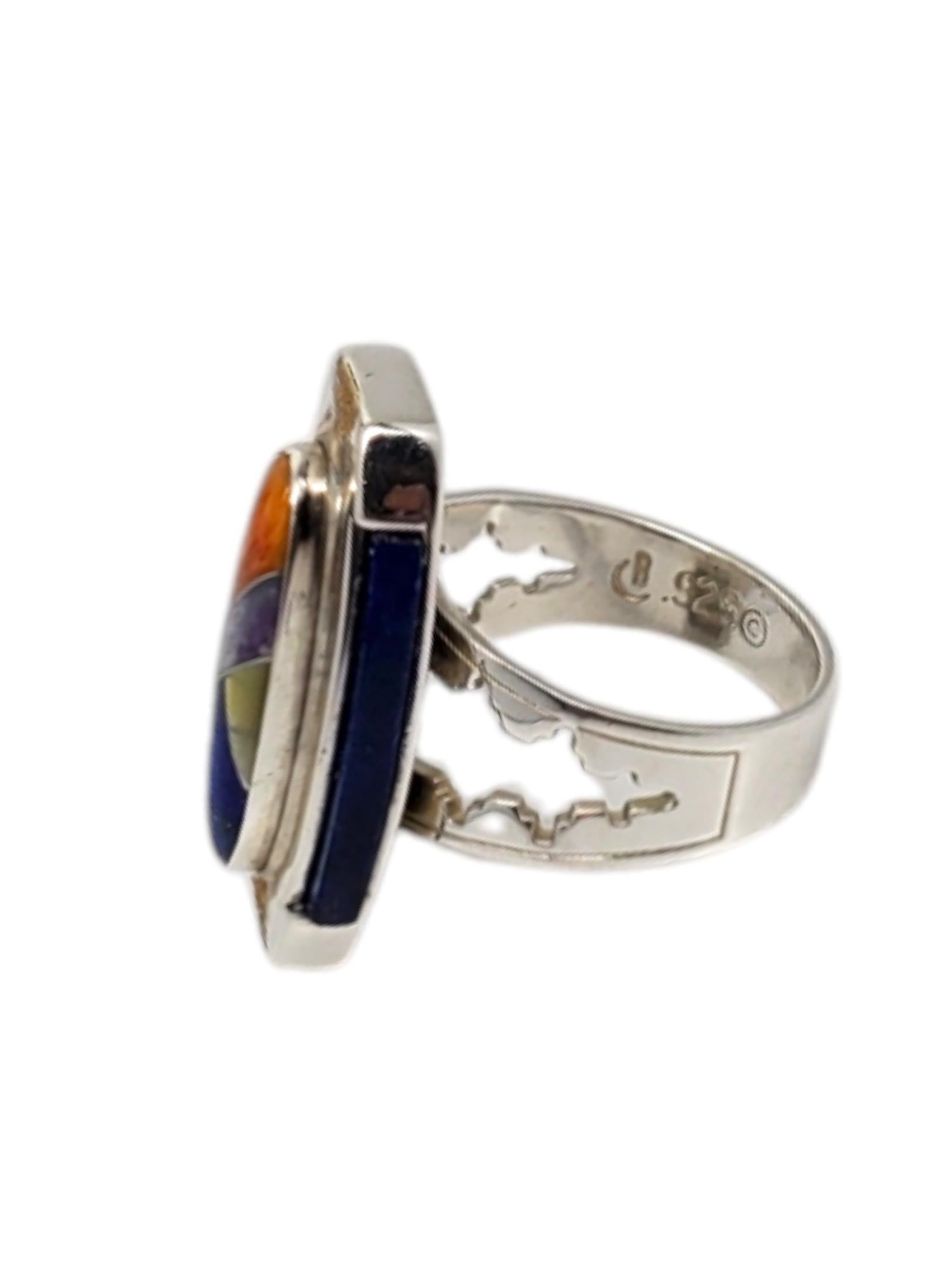 Carolyn Pollack Sterling Silver & 14K  Inlay Multi-Gemstone Ring -

This unique sterling silver & 14K ring by Carolyn Pollack features a geometric multi-stone inlay with 2 long Lapis pieces on each side.

Size: 8

Shank: 5 mm

Stamped: CR
