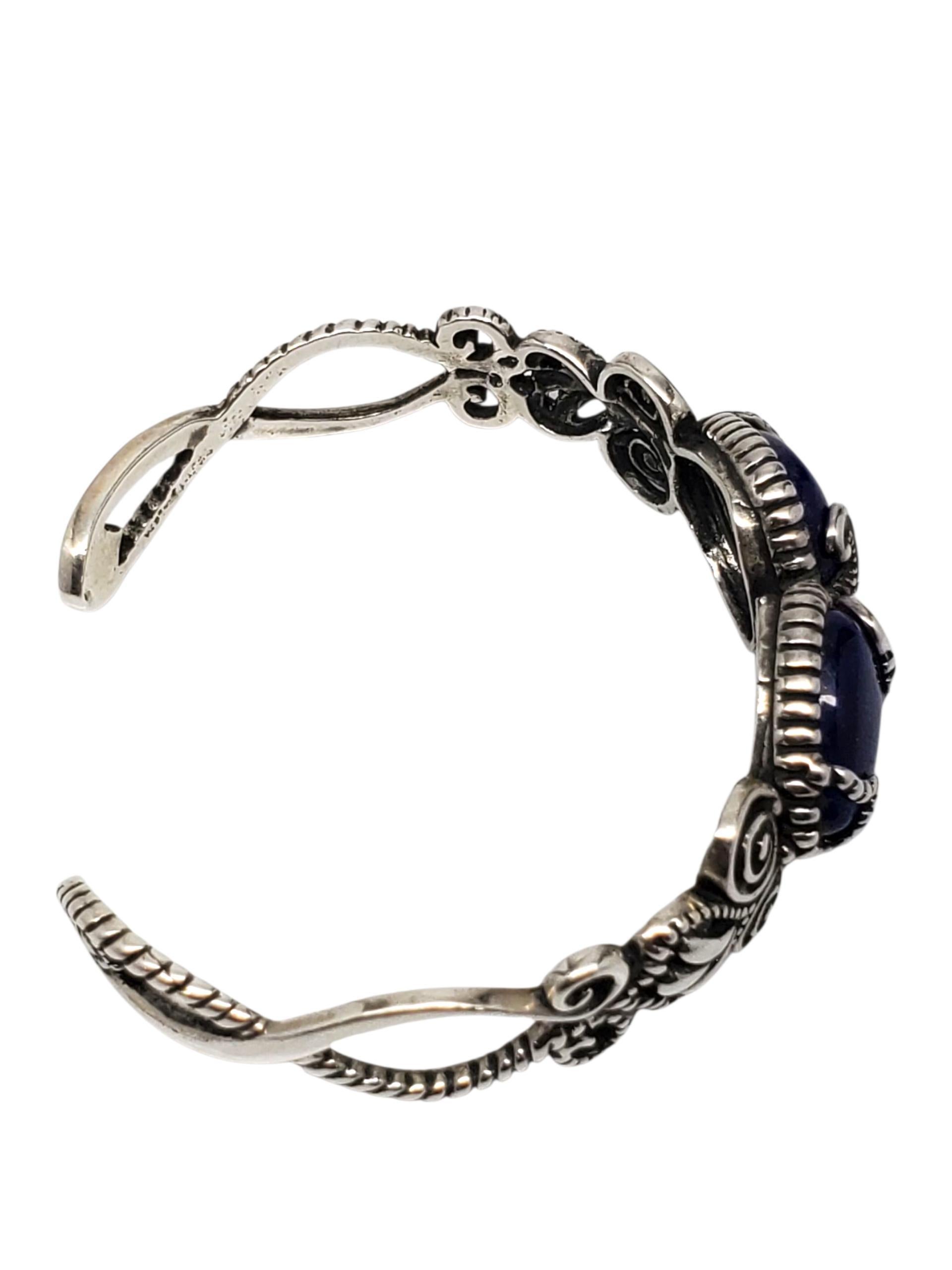 Bracciale con doppia pietra blu in argento sterling di Carolyn Pollack -

Questo bracciale vintage di Carolyn Pollack presenta 2 pietre cabochon blu a forma di goccia incastonate in un design a spirale e corda in argento sterling.

Dimensioni: 6 1/4