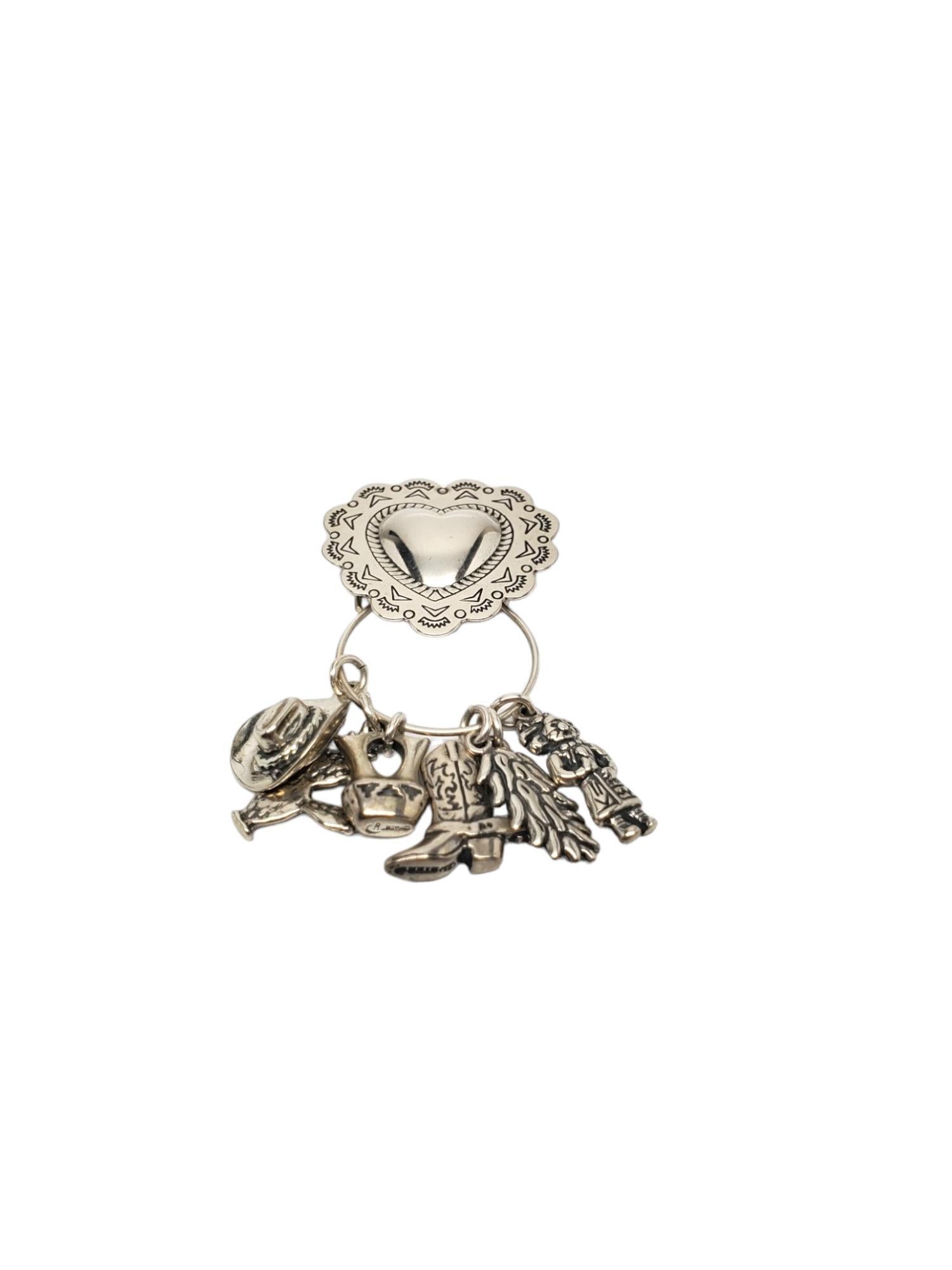 Carolyn Pollack Sterling Silver Heart Charm Holder Pendant with Charms-

This lovely Carolyn Pollack charm holder features various charms crafted in beautifully detailed sterling silver.

Charms include cowboy hat, cactus, peppers, cowboy boot,