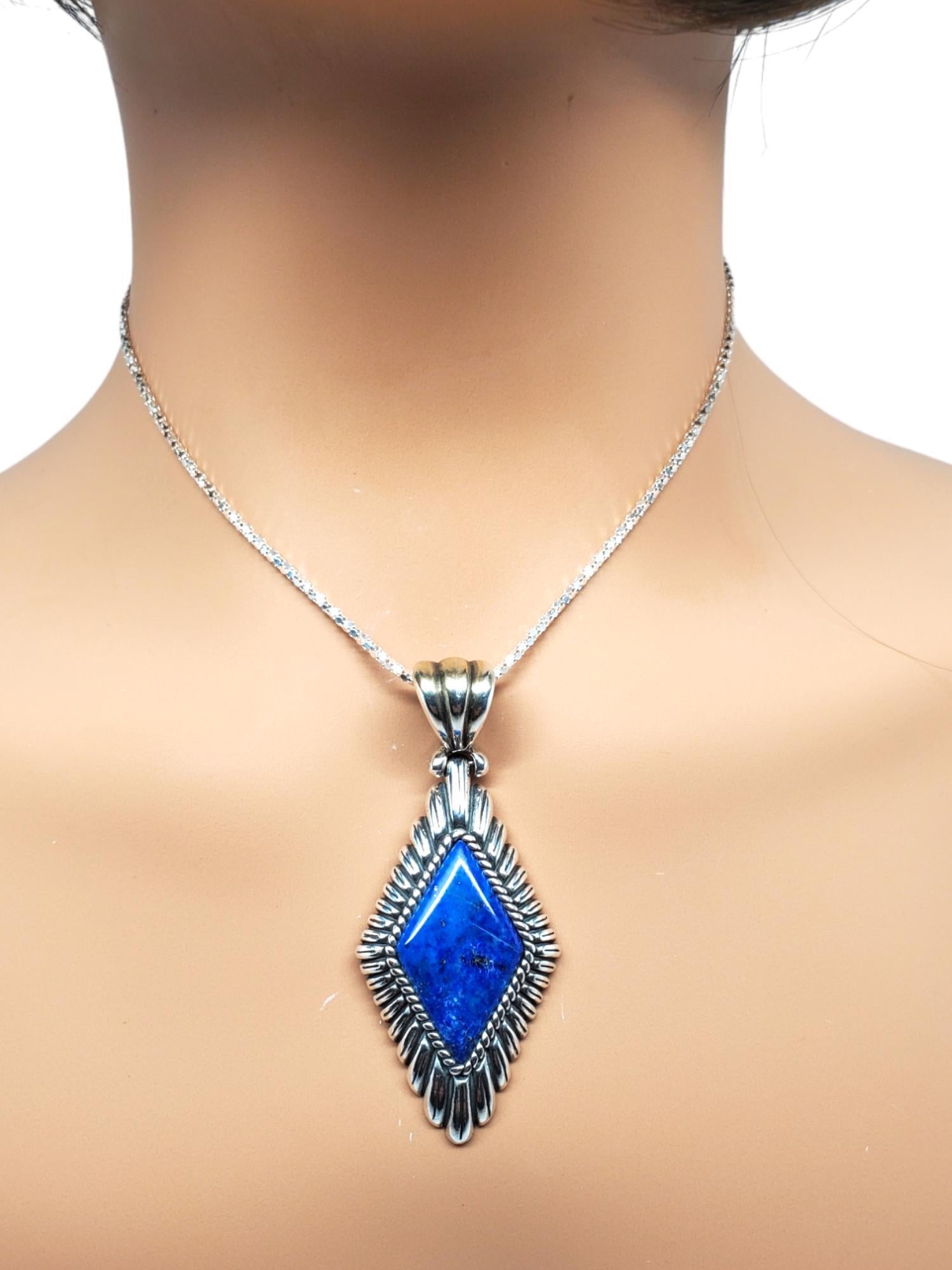 Carolyn Pollack Sterling Silver Native American Lapis Lazuli Pendant-

This lovely pendant features one diamond shaped lapis lazuli stone (1.15 mm x 0.67 mm) set in beautifully detailed sterling silver with fluted border.

Size: 2.5 x 1.1