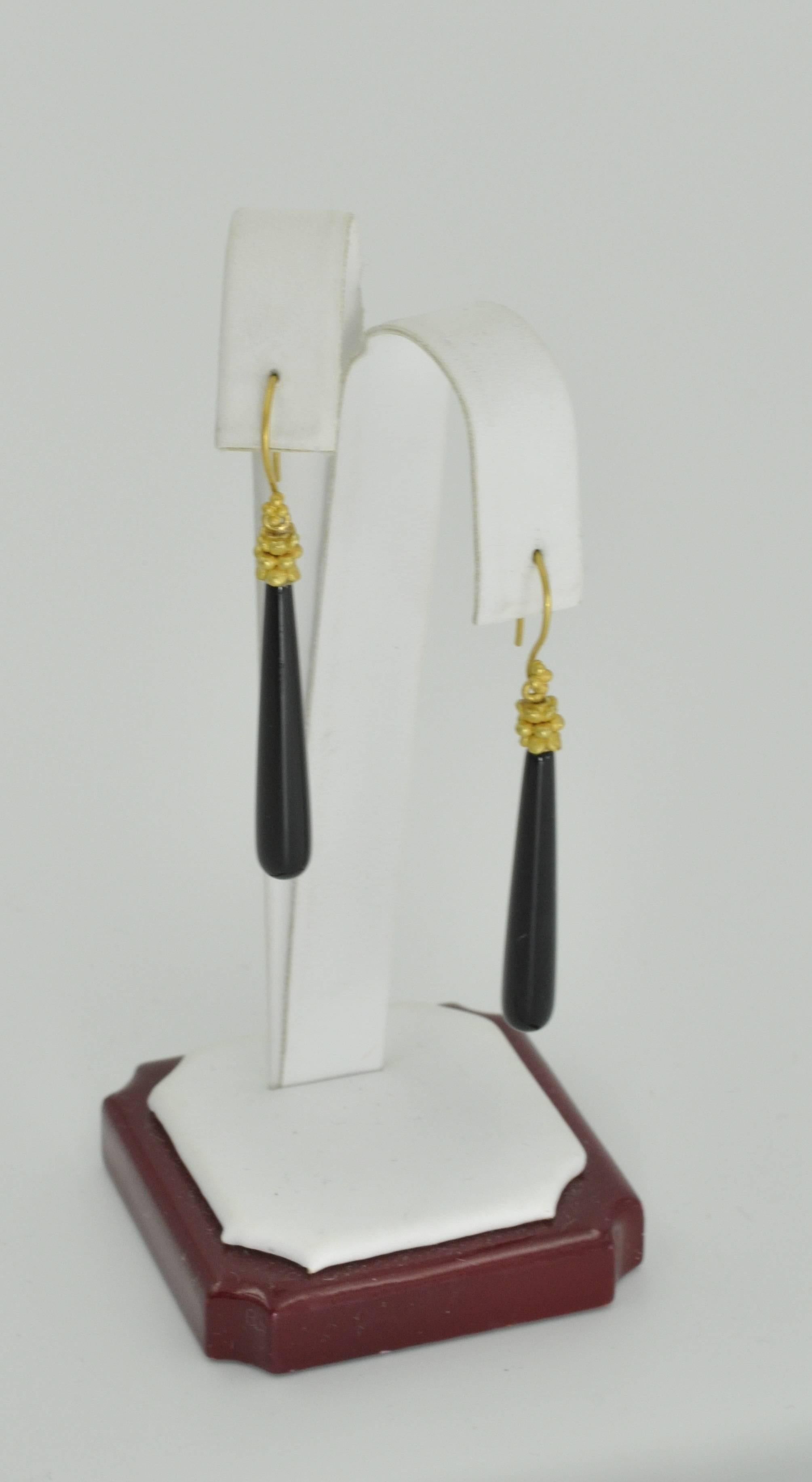 These gorgeous, delicate dangle Black Onyx drops are created by renowned designer Carolyn Tyler. The earrings are made of 22k yellow gold and 18.5ct Black Onyx Agate with dainty ear hooks.