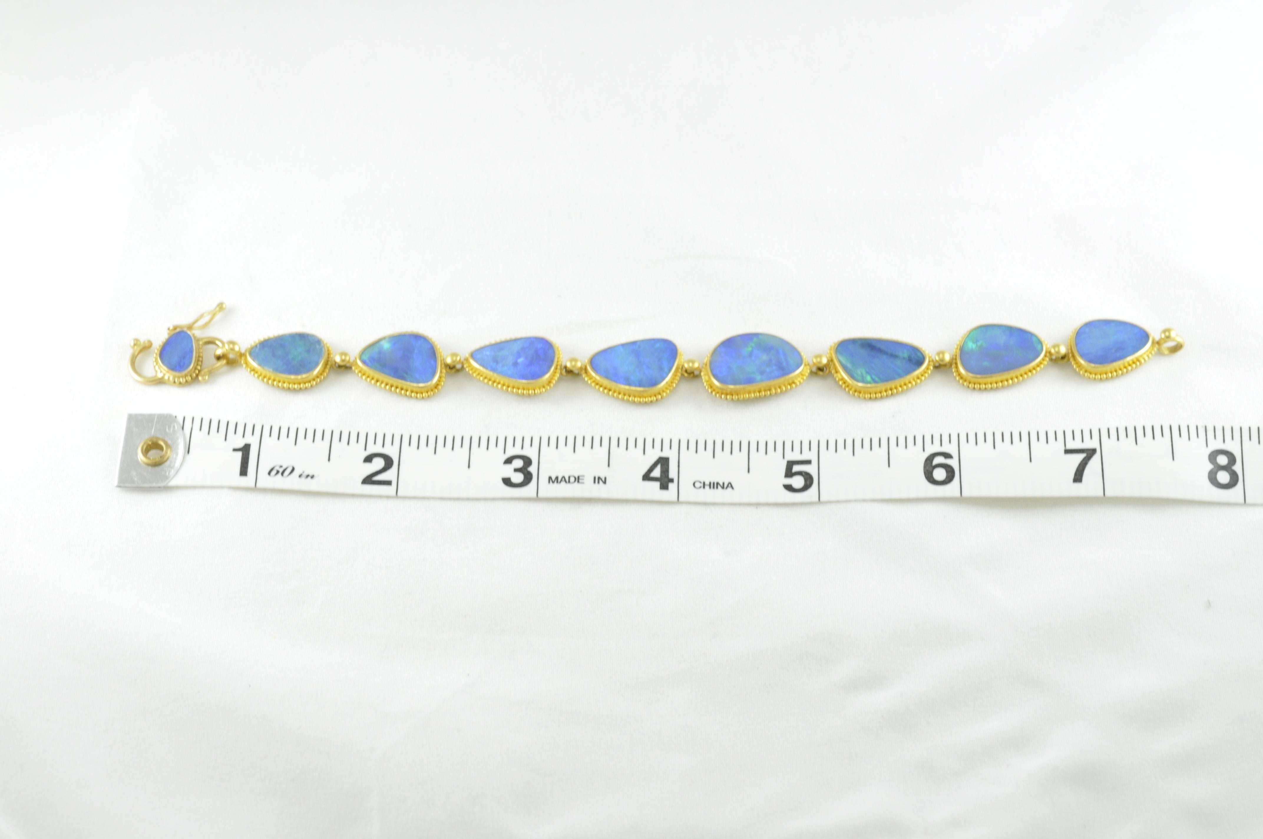 Carolyn Tyler 22k Gold 46ctw Boulder Australian Opal Doublet Bracelet.  7.5 inches long.  Width of the largest opal piece is .75 inch.  Granulation around the boulder opals.  