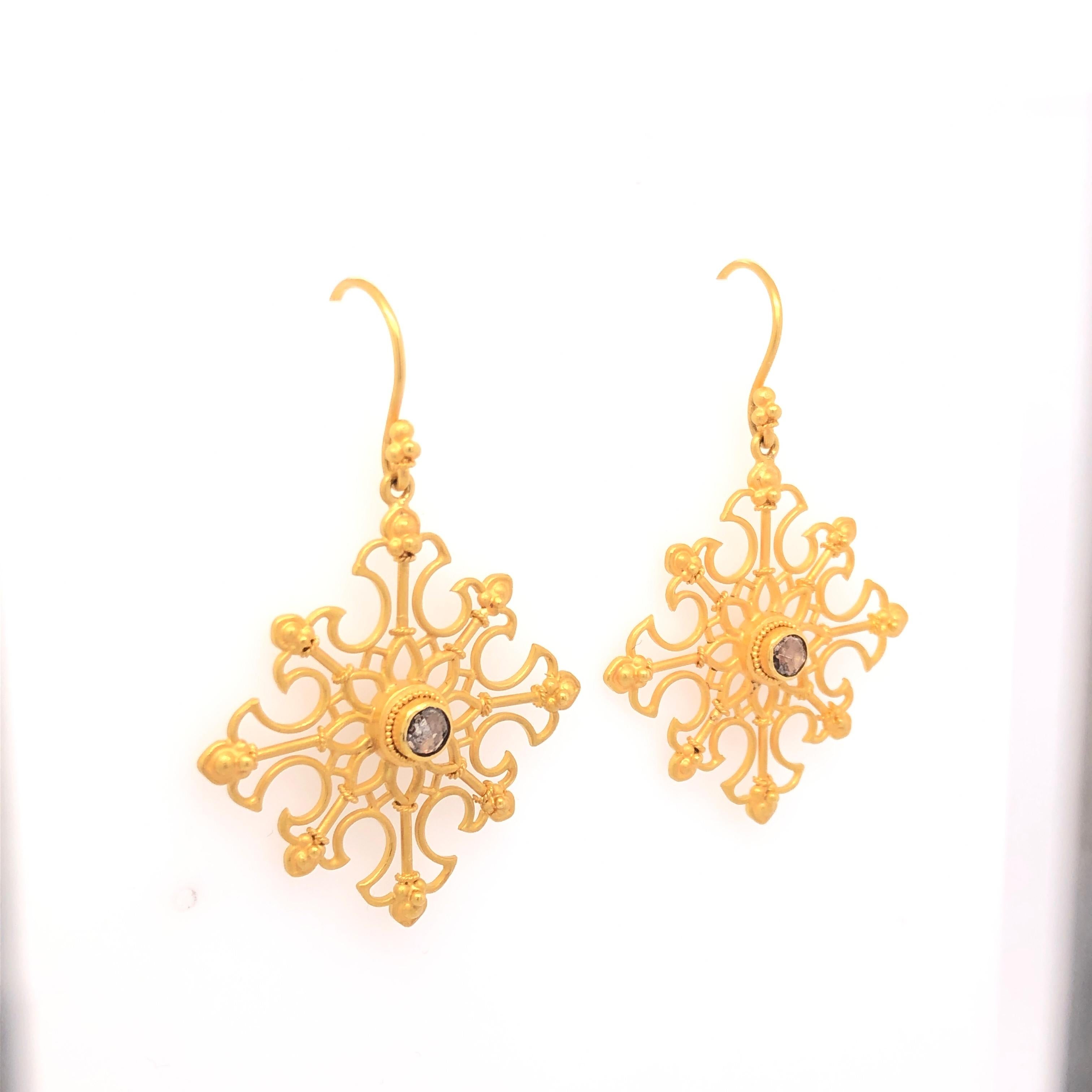 The beautiful design of Carolyn Tyler's Snow Flake earrings incorporates both western and eastern aesthetics. Bezel set diamonds sit in the center of the 18K gold snowflakes that delicately dress your ear. 

Stamped: 18K  