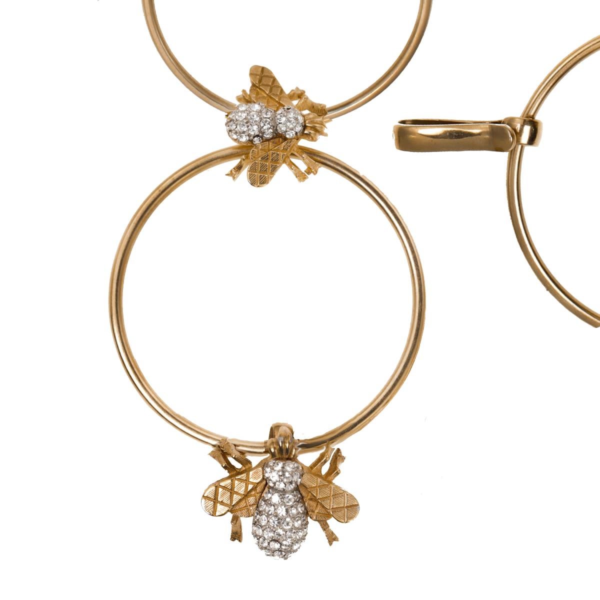 Large polished gold round hoops, adorned with CINER's signature heritage bee, creates a conversationally chic chain belt. With beautifully detailed quilted bee wings and Swarovski crystal rhinestone body, this belt is the perfect accessory to