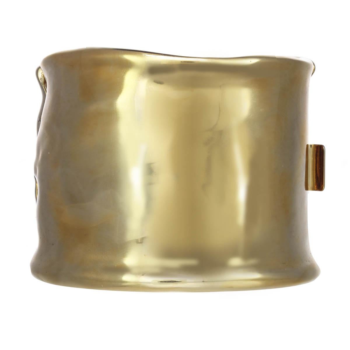 The perfect accessory for everyday wear, this 18K gold plated organic cuff is super chic.

Materials
Pewter
18K Gold Plating
Genuine Rhodium Plating
Swarovski Crystal Rhinestones
Swarovski Green Tourmaline Rhinestones 
Box and Tongue