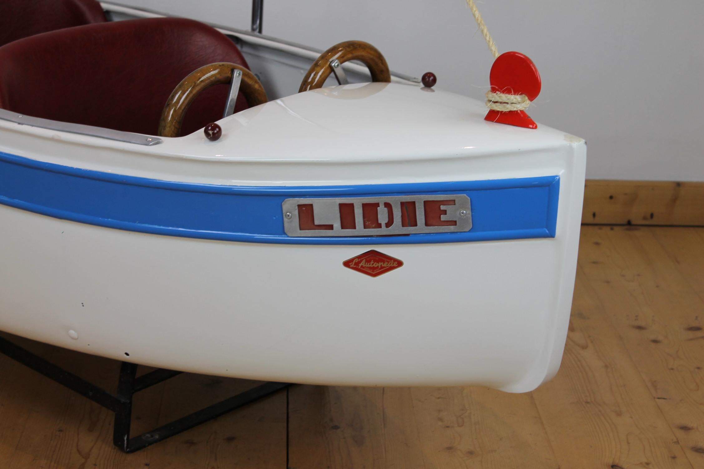 Carousel boat by Atelier L' Autopède Belgium. 
This merry-go-round hand-made metal boat is the first model of the first serie boats made by L' Autopède in 1948: it has a beautiful metal mast -where the name of the boat is given in - an ornament on