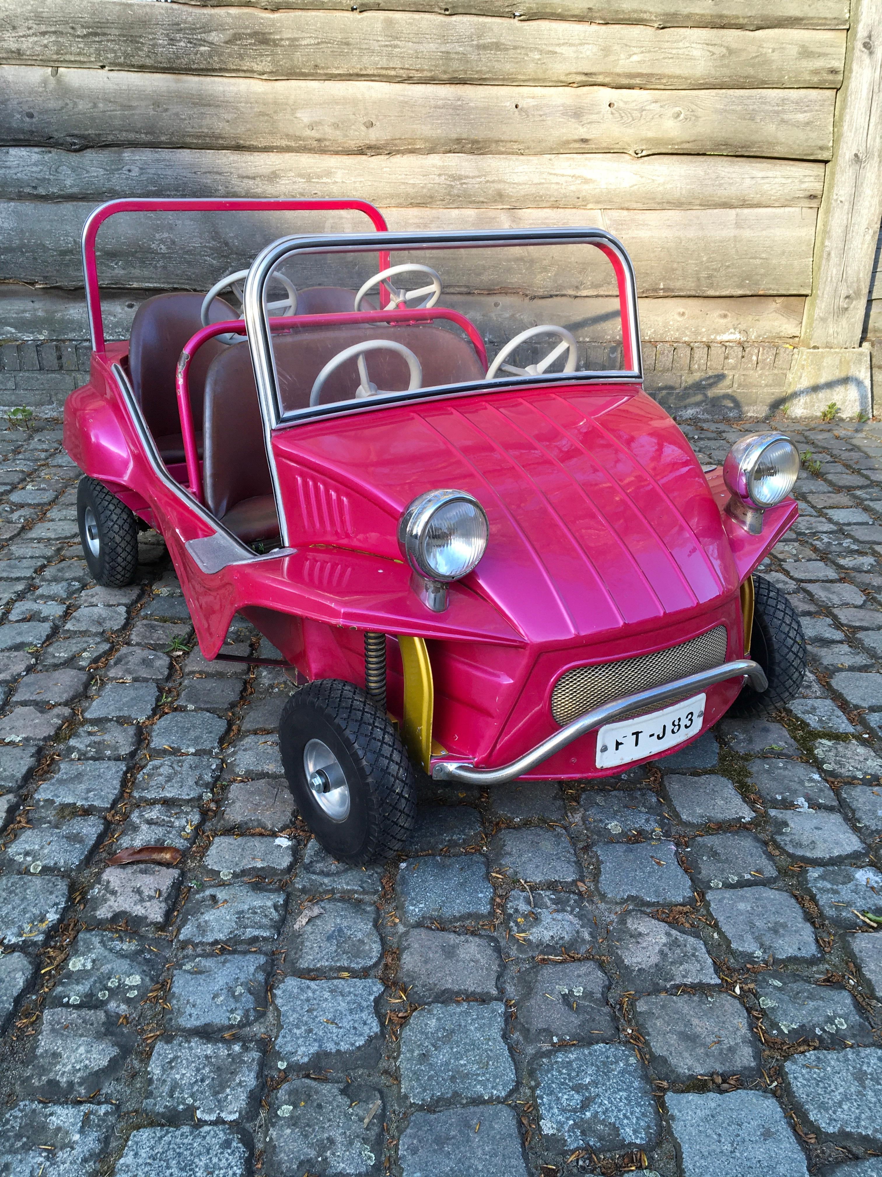 Pink Carousel Buggy Car by L’Autopède Belgium. 
Looks like a real vintage VW beach buggy car. 

This sheet metal carnival ride car with 4 seats dates from the 1970s. 
It's a handmade piece - so a real piece of art and craftmanship. 
In bright color
