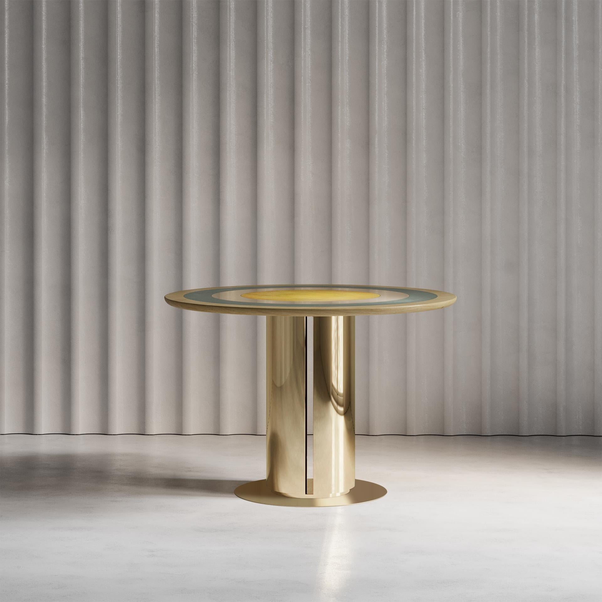 Inspired by the playfulness of a merry-go-round, the Carousel Dining Table Aurum combines both brass and wood. Using hand-spun brass, Solid Sycamore, Sycamore veneer, and a selection of our signature patinas, this Carousel piece plays with both