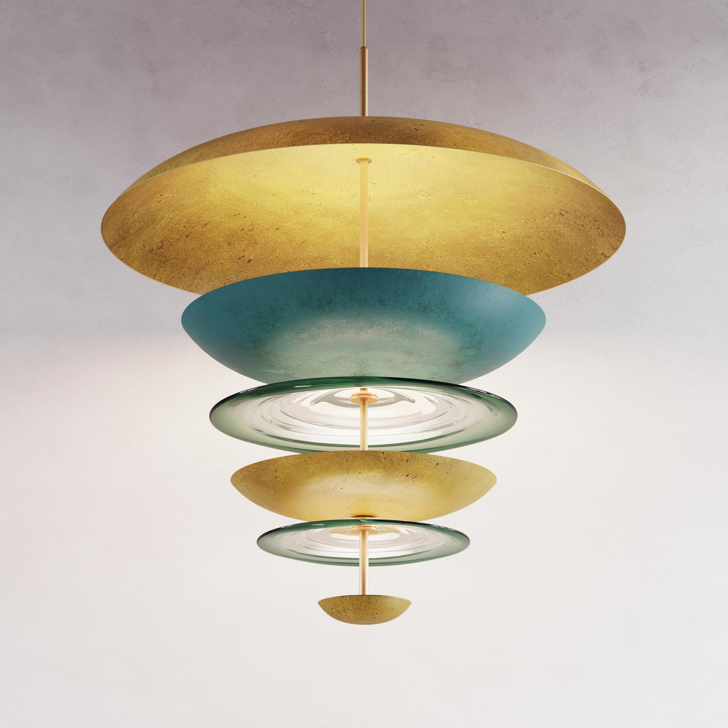 Inspired by the playfulness of a merry-go-round, the Carousel Chandeliers combine both of Atelier001’s signature collections, Cosmic and Liquid. Using hand-spun brass plates, hand-blown glass, and a selection of patinas, the Carousel pieces play
