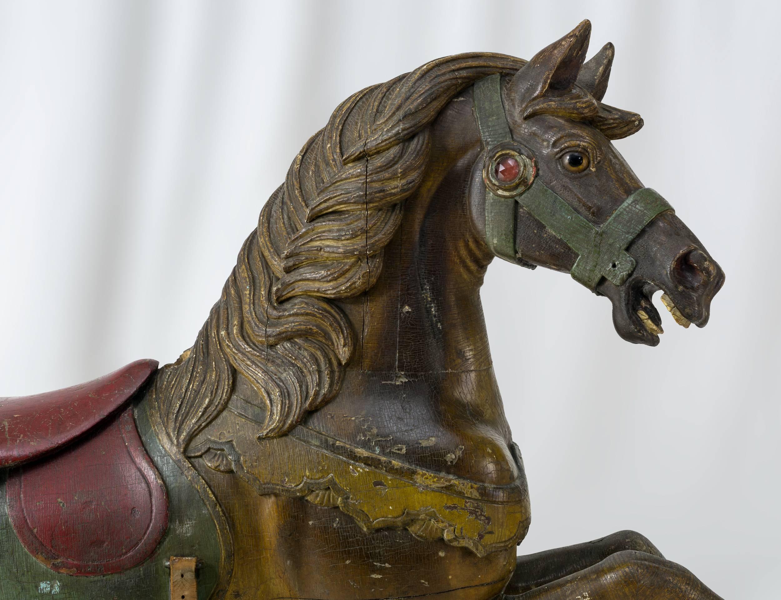 The prancing horse is carved from basswood
and has glass eyes and a faceted “Jewell” on harness.
Leather and iron stirrups. Retaining an excellent old surface
Germantown, PA, circa 1890-1910.


 