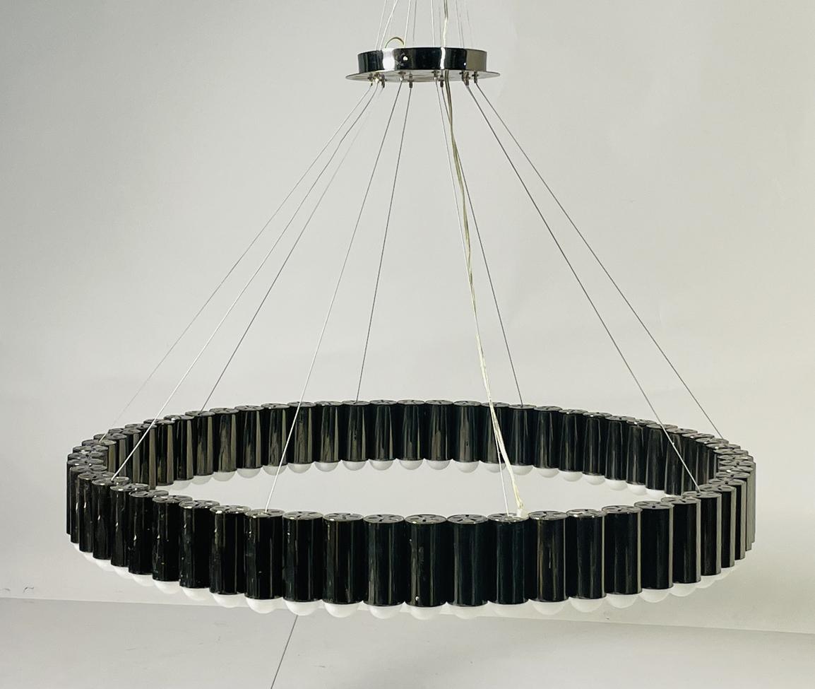 Inspired by the merry-go-round ride of a traditional British fairground. Cylinders house an inset LED lighting element resulting in a spectacular ring of light. Carousel XL is suspended from a matching circular ceiling plate by steel suspension