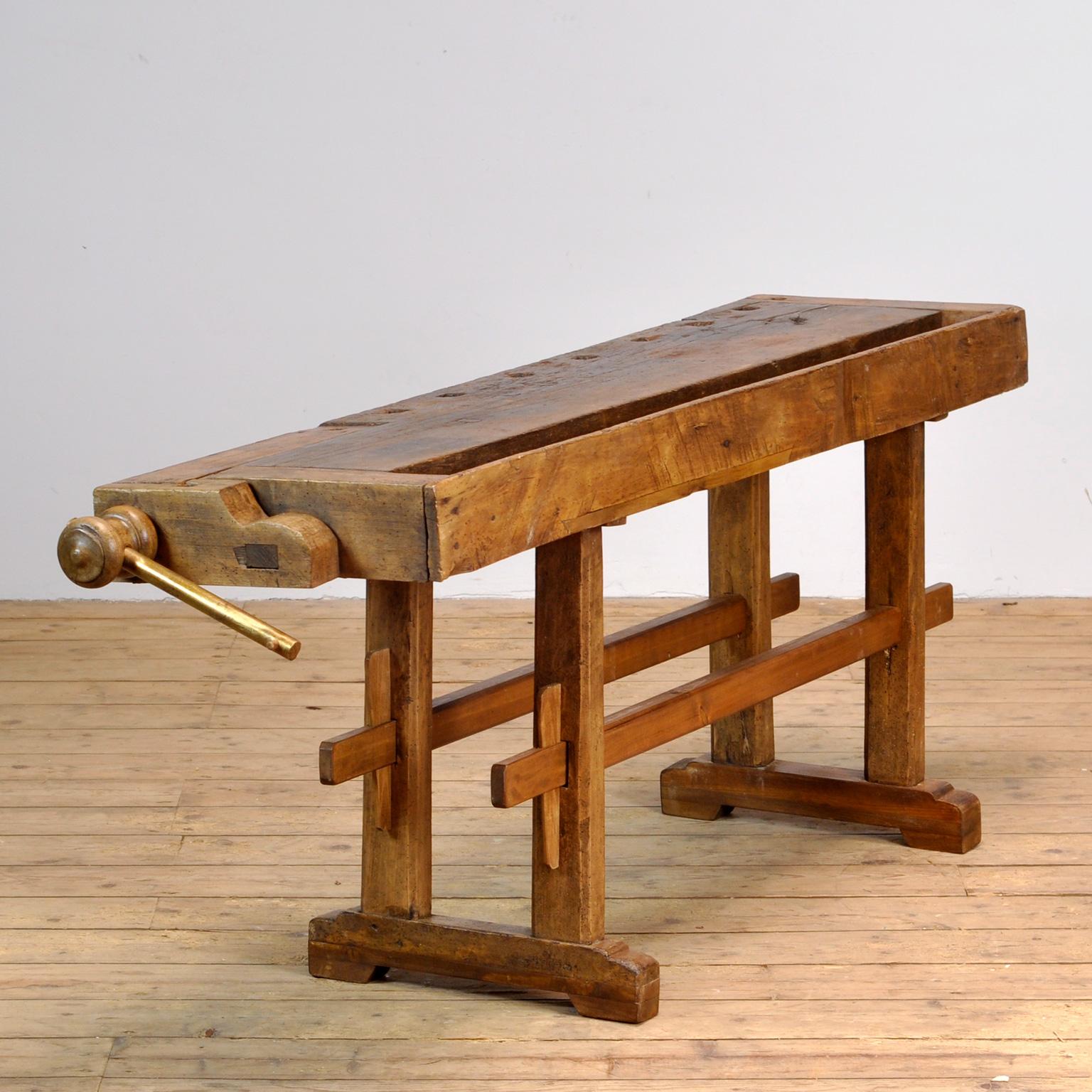 This antique workbench has one built-in wooden vices screw and a recessed tray where the carpenter would put his tools. It was manufactured around 1900. Made from oak. Beautiful patina after years of use. The workbench has been treated for woodworm,