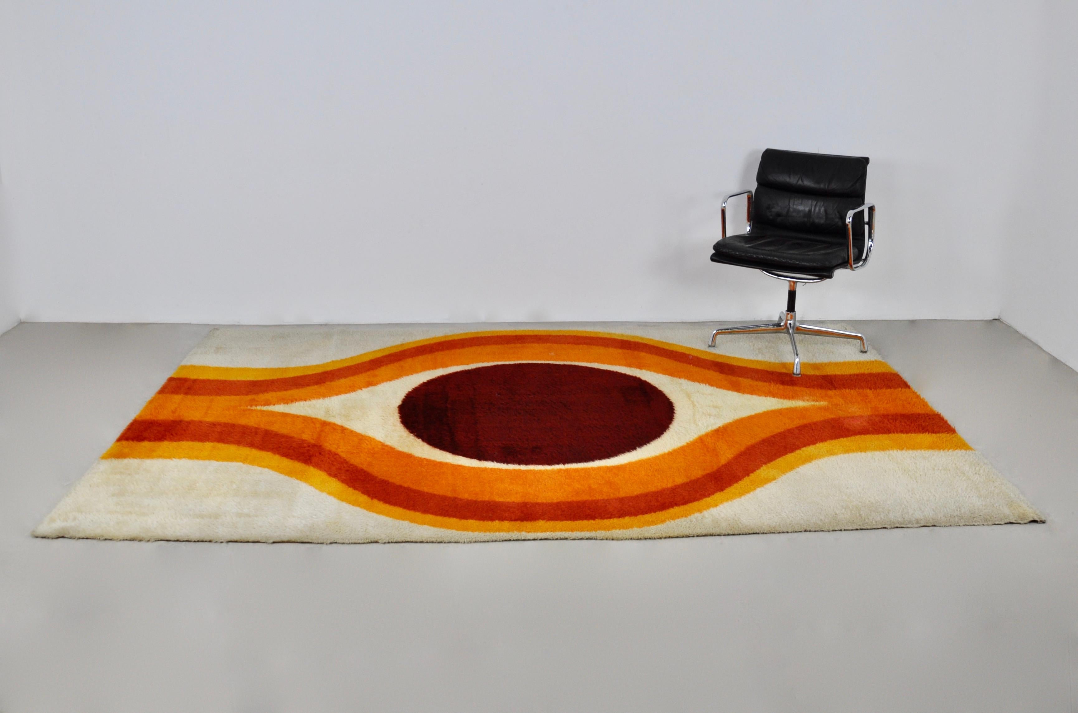 Wool carpet with patterns of different colors stamped on the bottom.