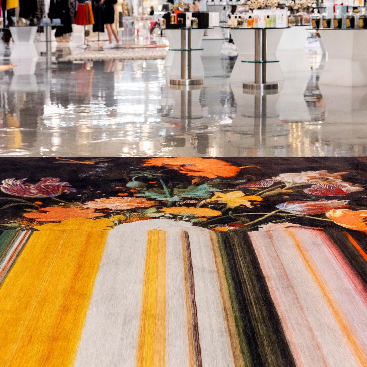 Images of charming coloured flowers are stretched in lines to reveal their beautiful colours. It is as if the image of the flowers is not downloaded correct on your computer screen. The traditional floral pattern meets the digital age. The refined