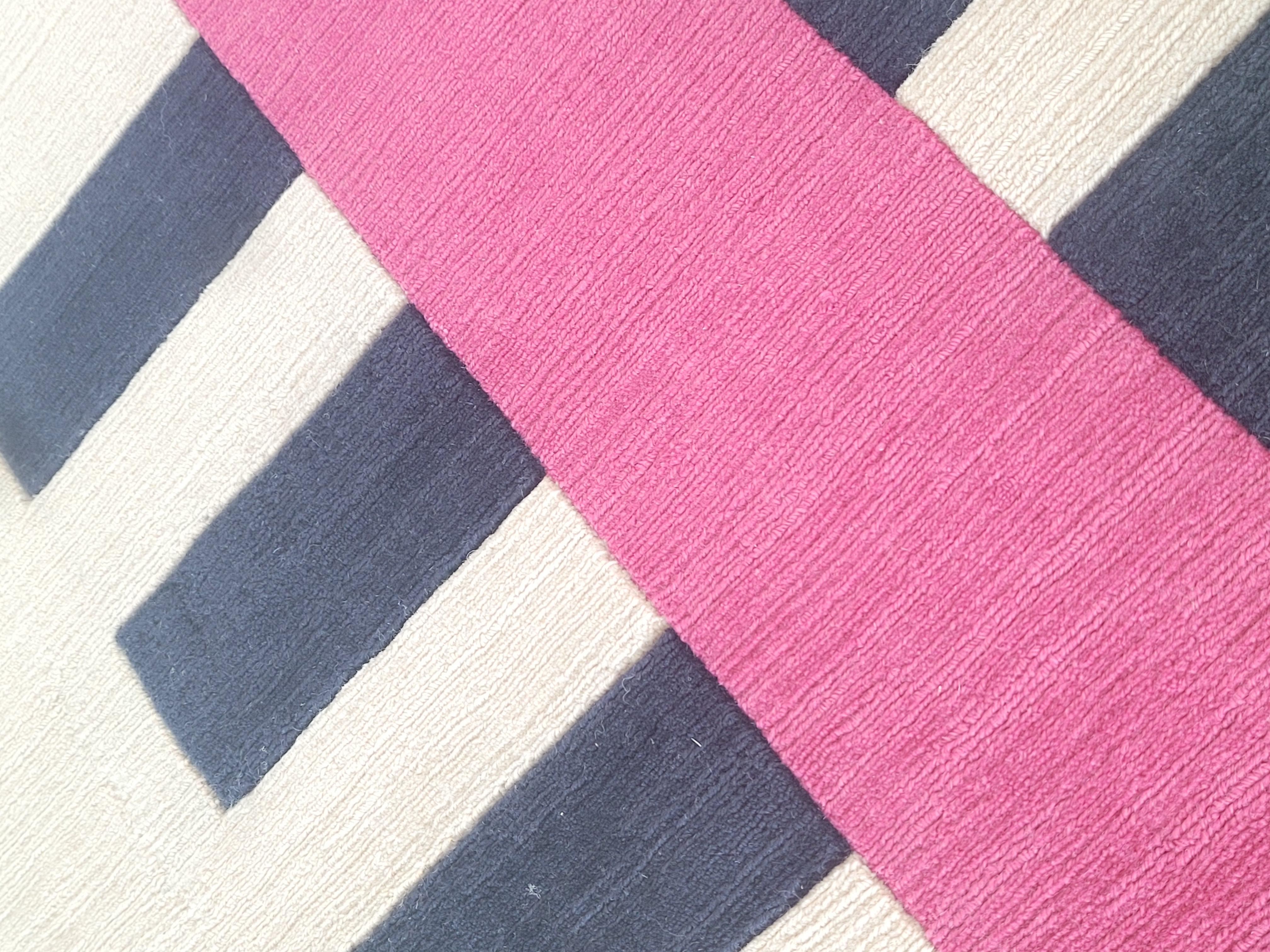this carpet is woven on a hand/loom in a technique called 'tip shear' which gives a beautiful texture and a soft feeling on the surface.
 The surface is a mix of loops and cut yarn, that gives a shimmering look. The design is inspired by boxes in