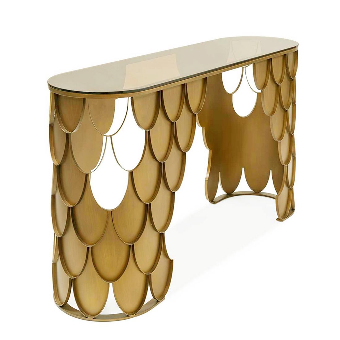 Console Table Carpus Matte with forged 
metal structure in matte brass finish and 
with oval glass top in bronze finish.