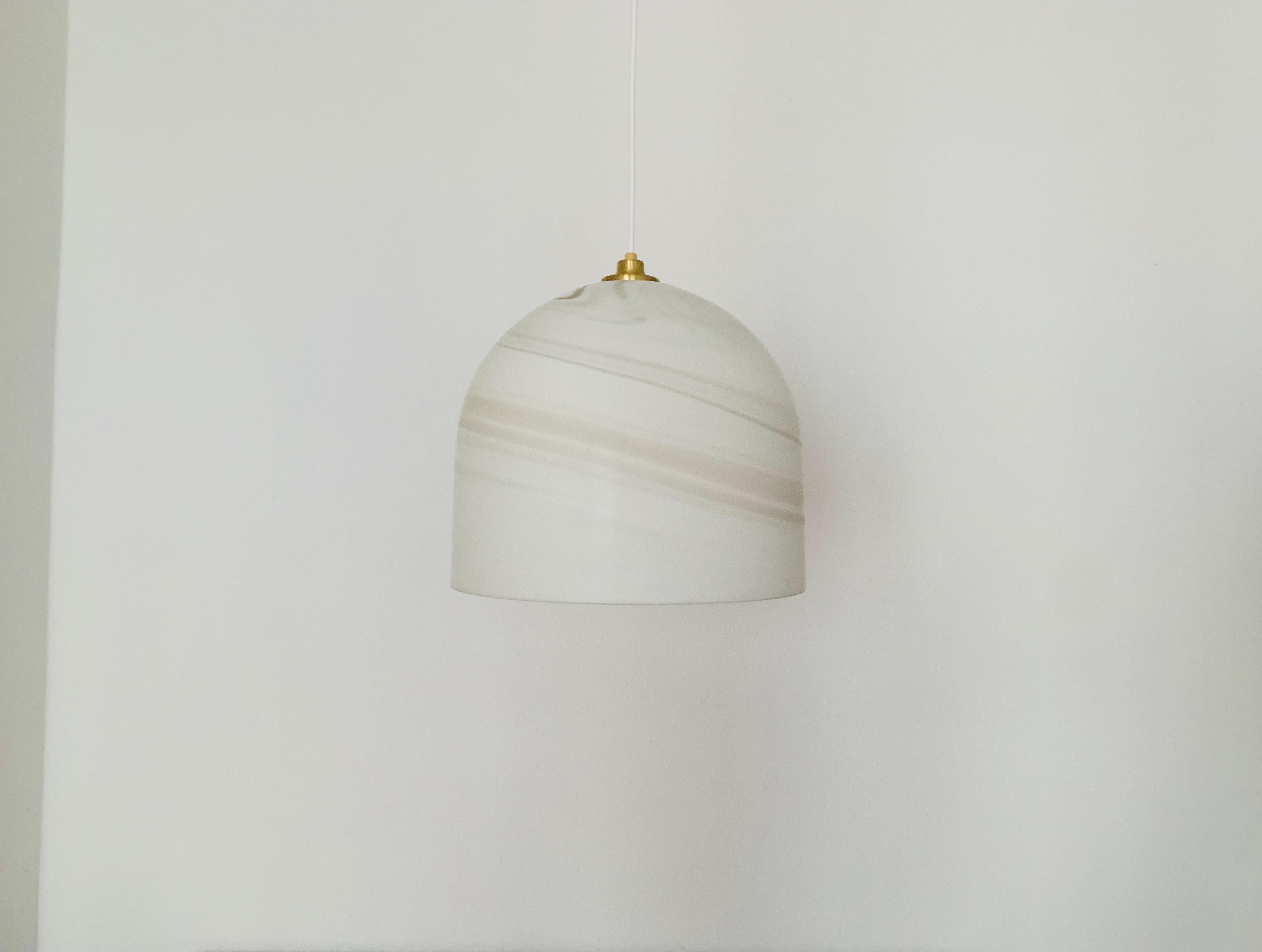 Exceptionally beautiful Carrara glass pendant lamp from the 1960s.
Very fine and beautiful design which fits wonderfully into any room.
The structure in the glass creates a beautiful and very comfortable light.

Manufacturer: Peill and