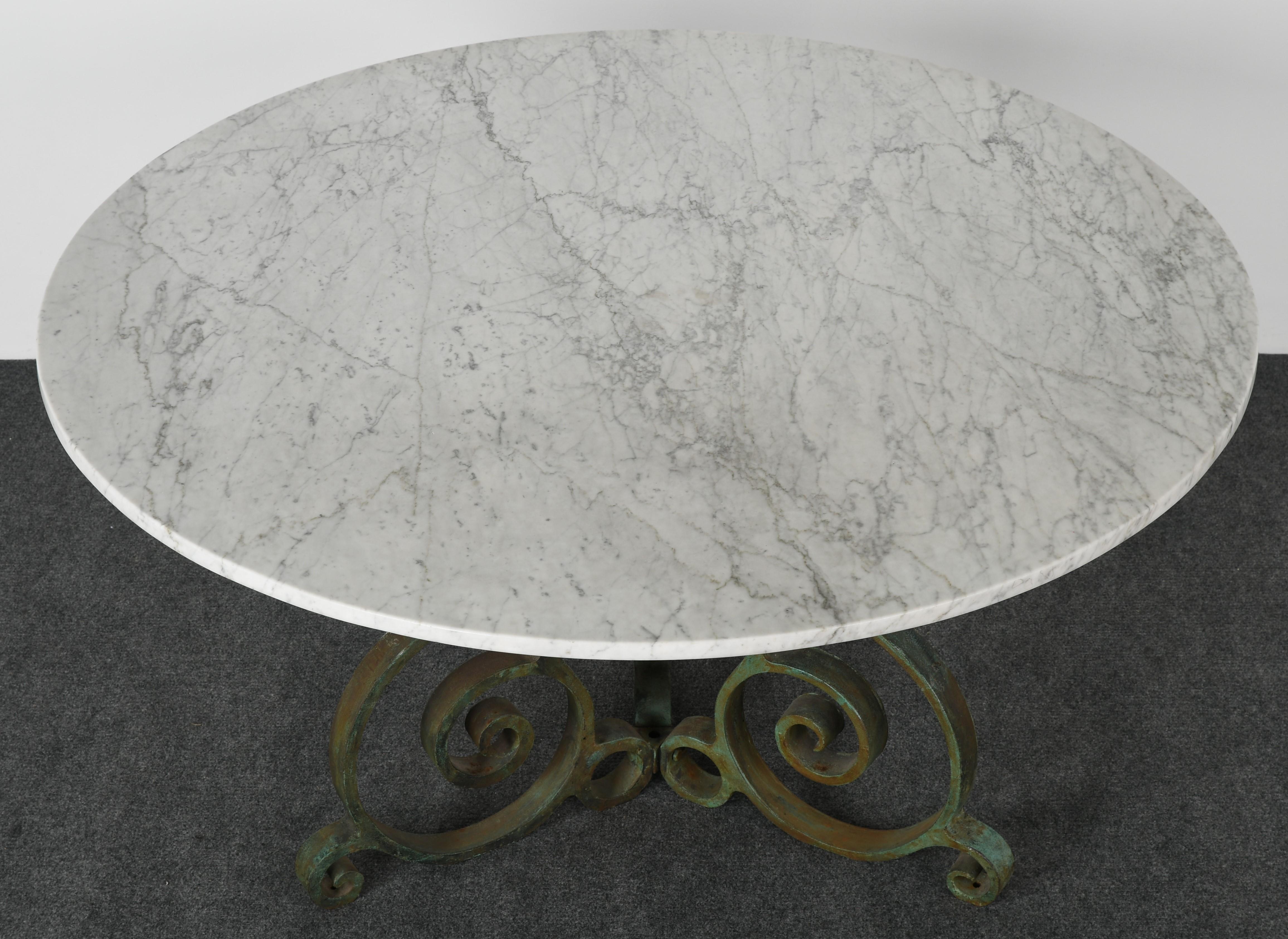 A beautiful Carrara marble and cast iron garden table, the 1950s. Cast iron base has very nice paint and some rust showing through with great patina. Marble has small divets, as shown in images, but not distracting.

Dimensions: 54