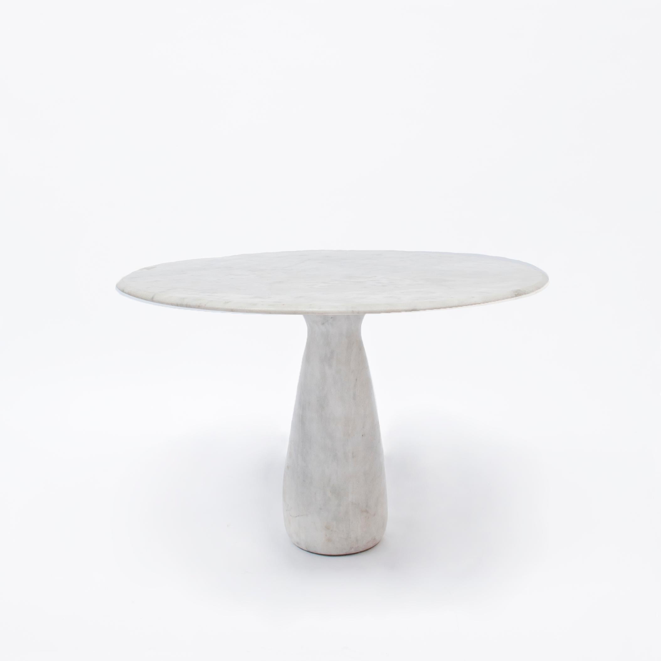 This table is a skillful example of Postmodern design. One solid marble pedestal holds a minimalistic tabletop. A great Classic for a versatile use designed in the midcentury style.