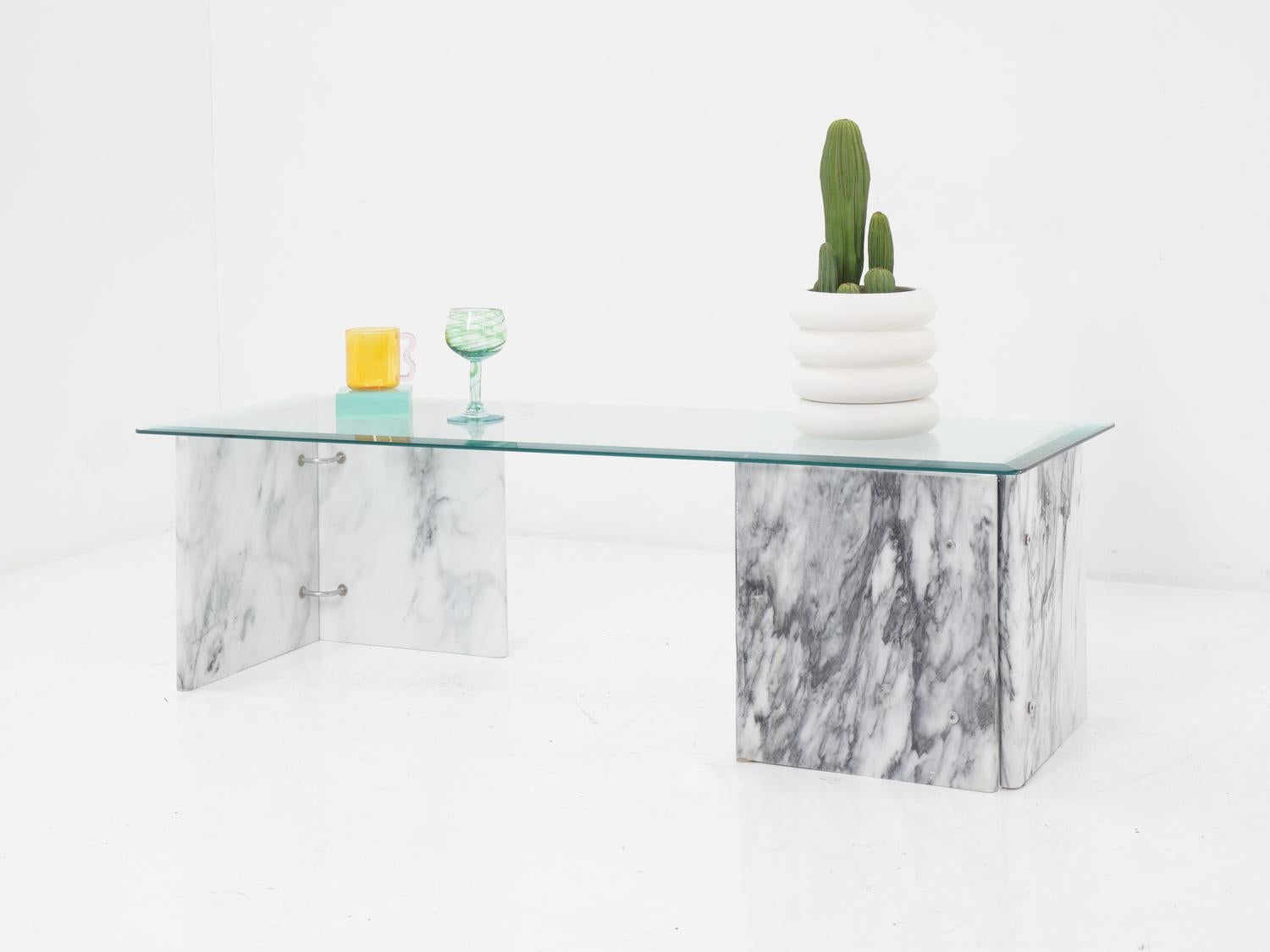 This Carrara marble base coffee table with a rectangular glass top is what dreams are made of. It's like the angel of elegance and the god of style got together and had a baby, and that baby is this coffee table. Plus, it's got a sturdy base, so you