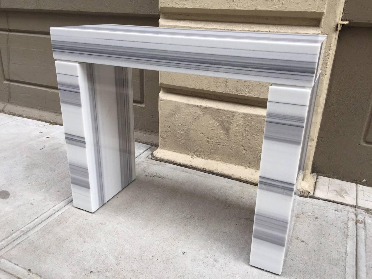 Carrara marble console / fireplace mantel in three parts. Nice shades of gray.