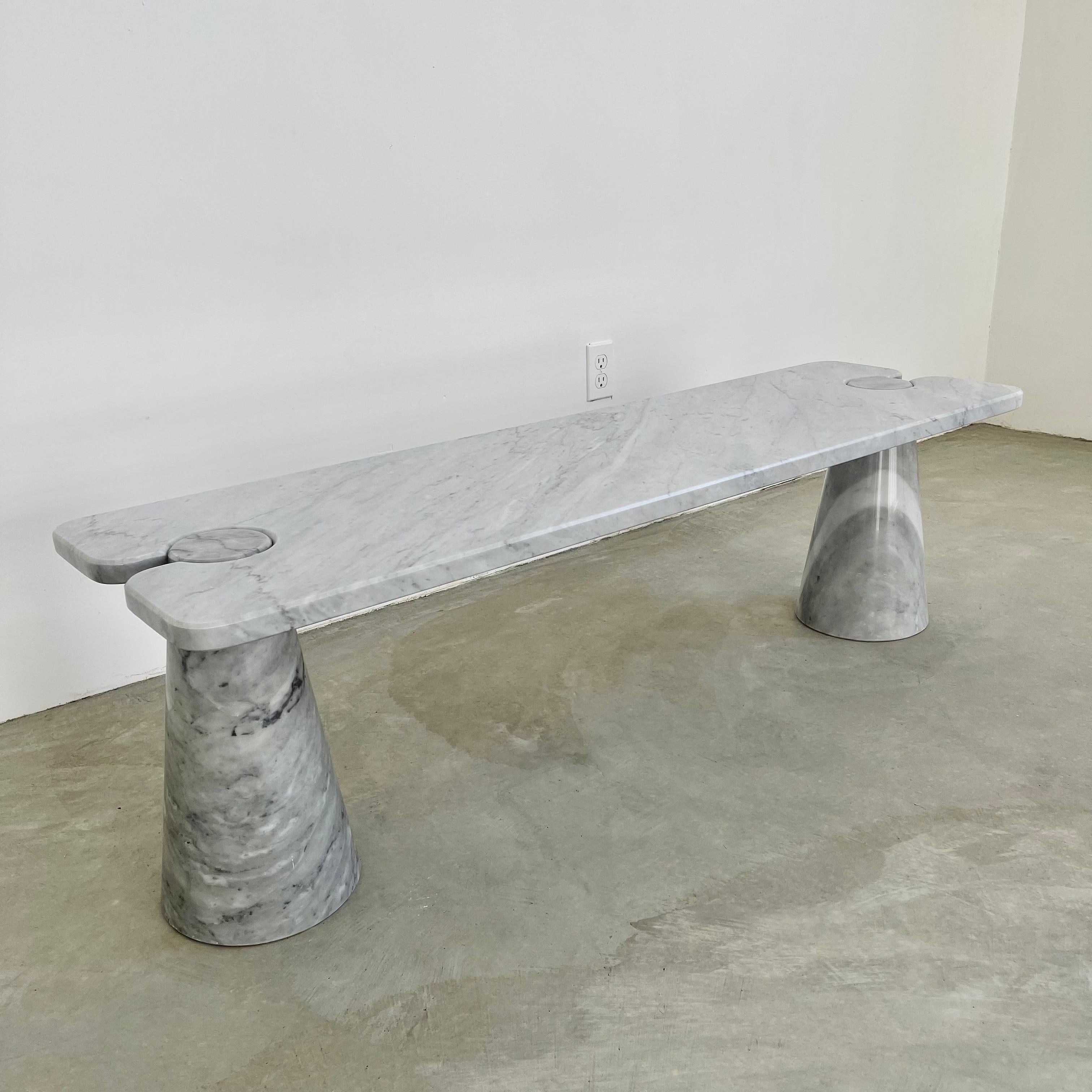 Stunning Carrara marble coffee table attributed to Angelo Mangiarotti. Large cone shaped bases hold a large slab of marble with circular cut outs. Extremely heavy and well made. Strong enough to be used as a bench if desired. White and blue/grey
