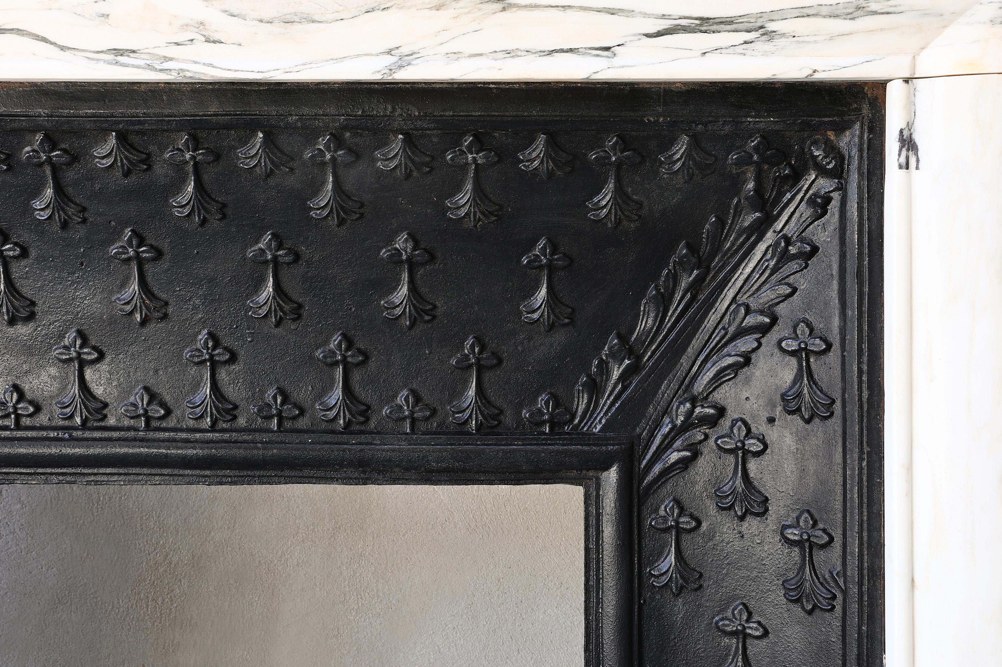 Beautiful Carrara marble mantelpiece with cast iron insert from the 19th century in the style of Louis XIV. A mantelpiece with straight shapes, flutes on the legs and a warm appearance! The cast iron insert is an added value to this mantel and makes