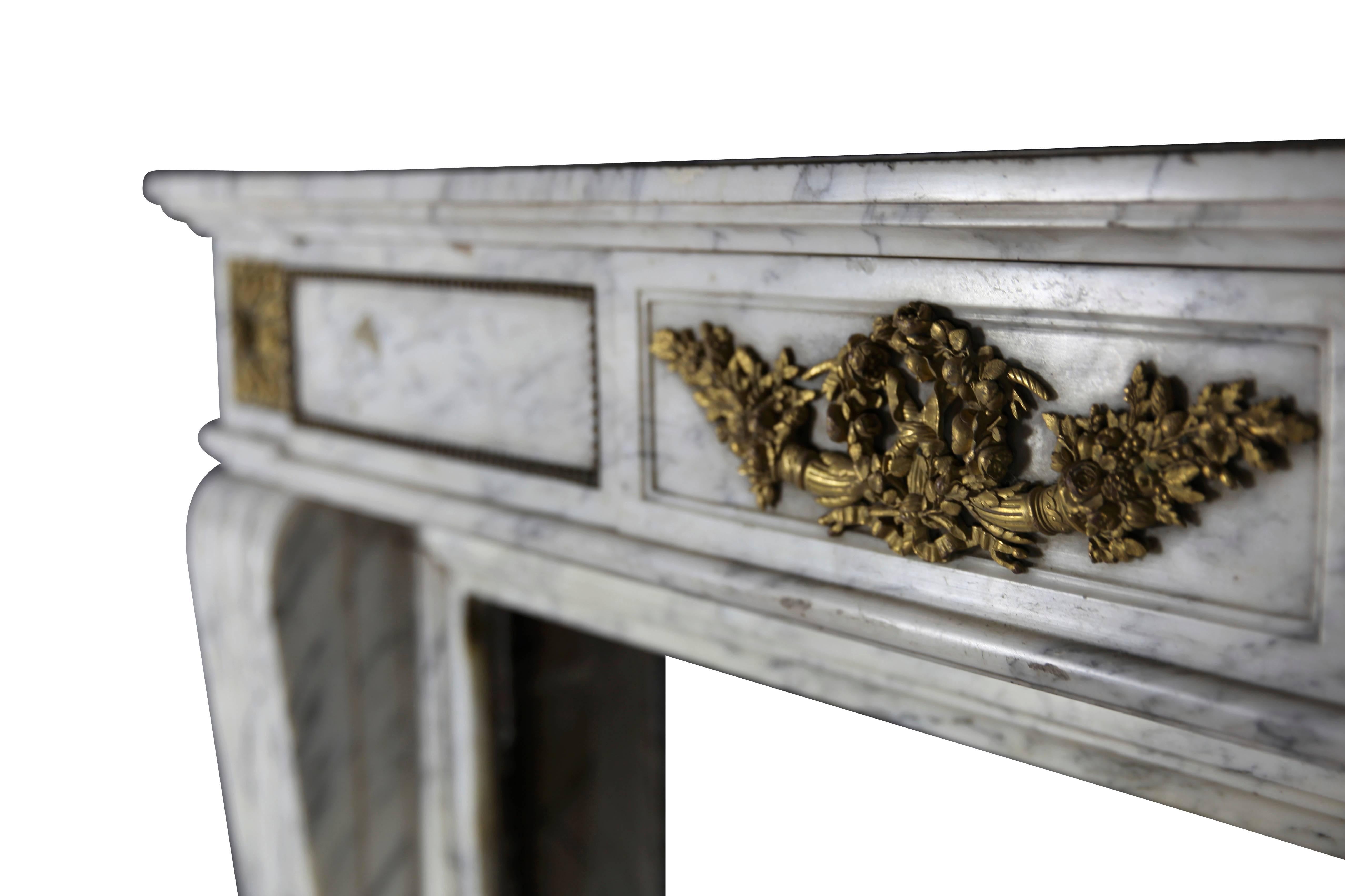 Original antique fireplace surround in white Carrara marble with original bijouterie in brass from the 19th century. A great element for a French classical interior. Louis XVI style.
Measures:
145 cm EW 57.08