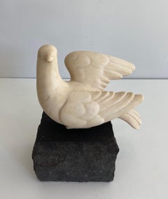 Carrara marble sculpture representing a dove resting on a stone base signed
