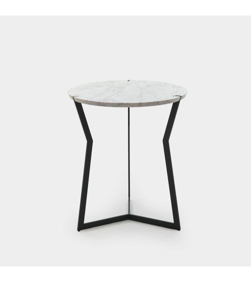 Carrara marble star side table by Olivier Gagnère
Materials: pedestal table, 20mm Carrara or Marquina marble top. Base in black bronze finish or gold lacquered metal.
Technique: lacquered metal, polished marble. 
Dimensions: diameter 50 x height