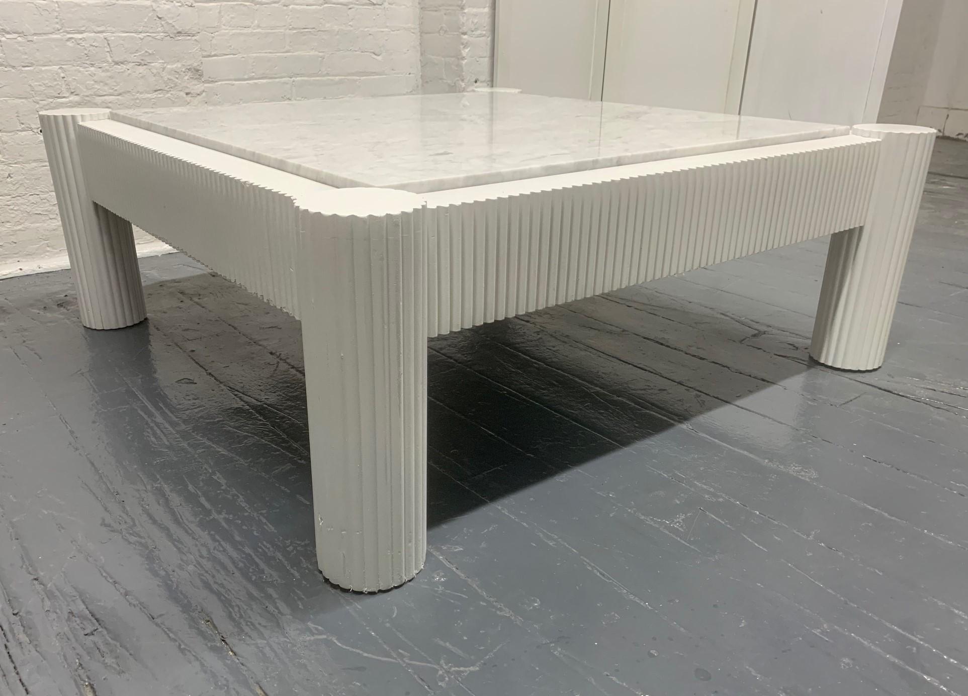 Sculptural white lacquered hardwood coffee table with a Carrara marble top. Well made.