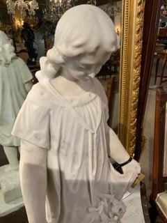 Carrara white marble sculpture of a young girl with flowers