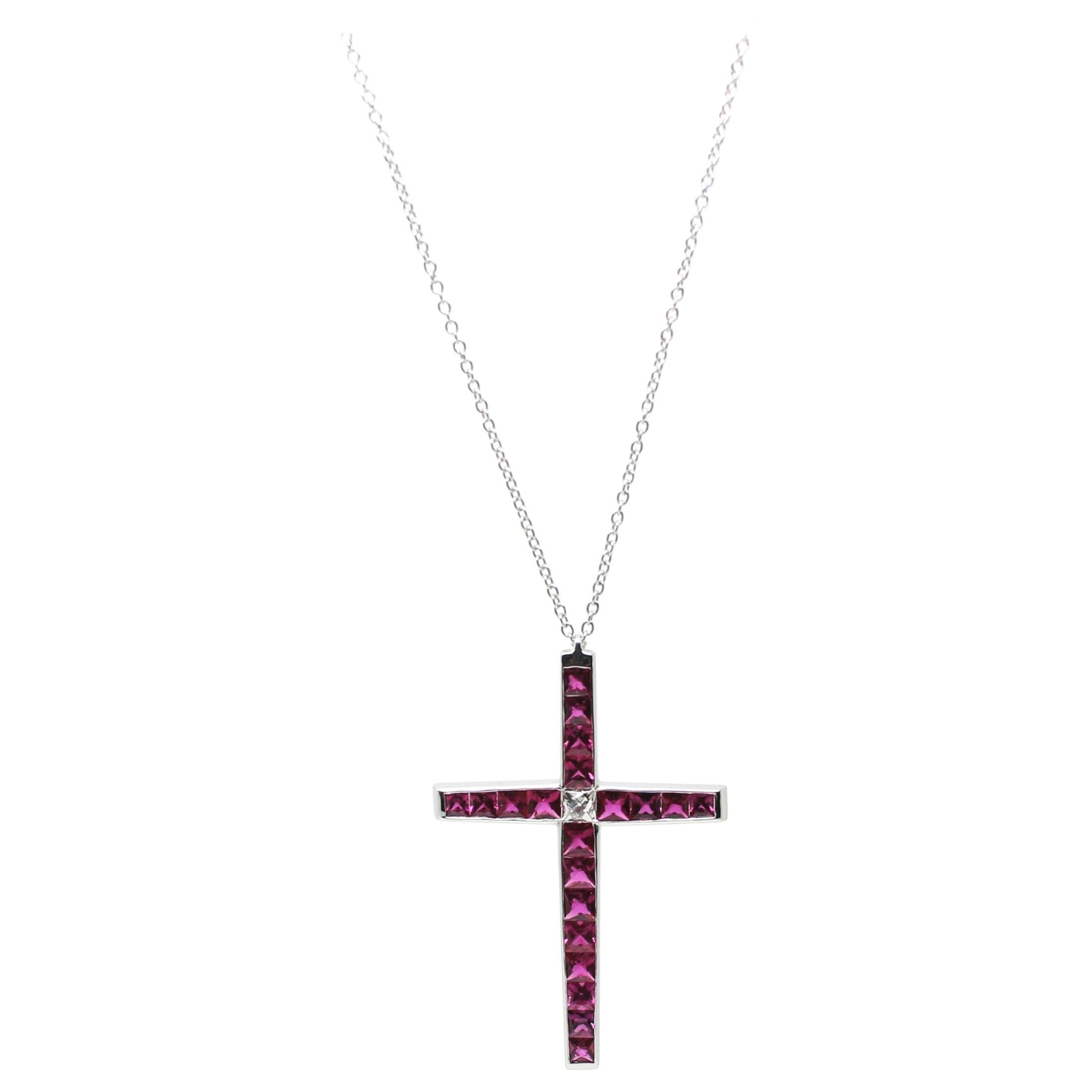 Perfectly Modern Designed Carrè Ruby Cross composed of  20 Ruby for 2.90 Carat total, with a French Cut White Diamond in the centre.
The Vivid Red of the Ruby matches and contrasts the Shining White of the Centre Diamond of 0.25 Carat..
This Cross