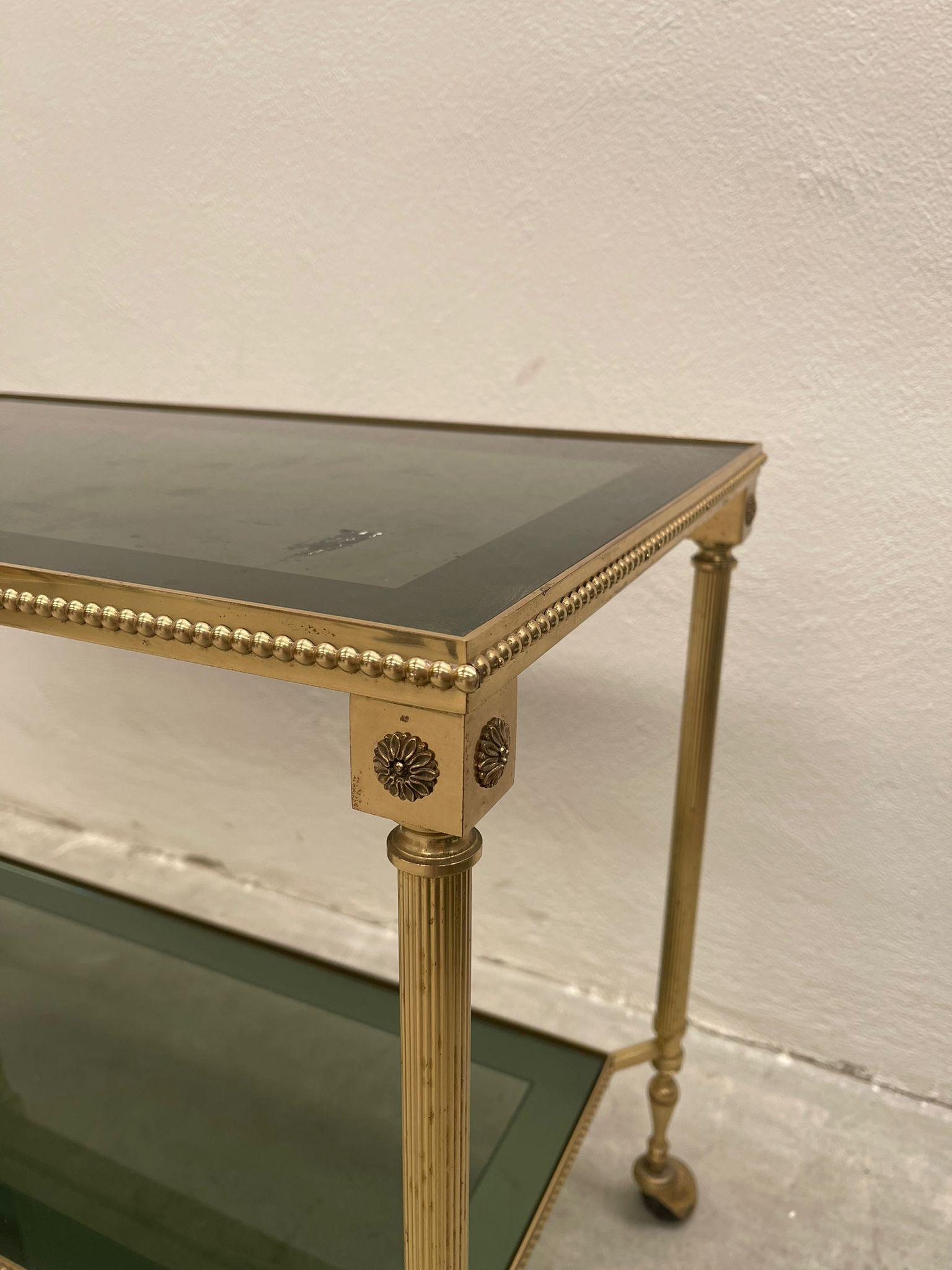 Multipurpose trolley made in Italy around 1960. Very delicate and fine decorations with a touch of uniqueness thanks to the silvered brass glasses. 
Perfect for any type of decor where you want to give it a greater touch of class and elegance.