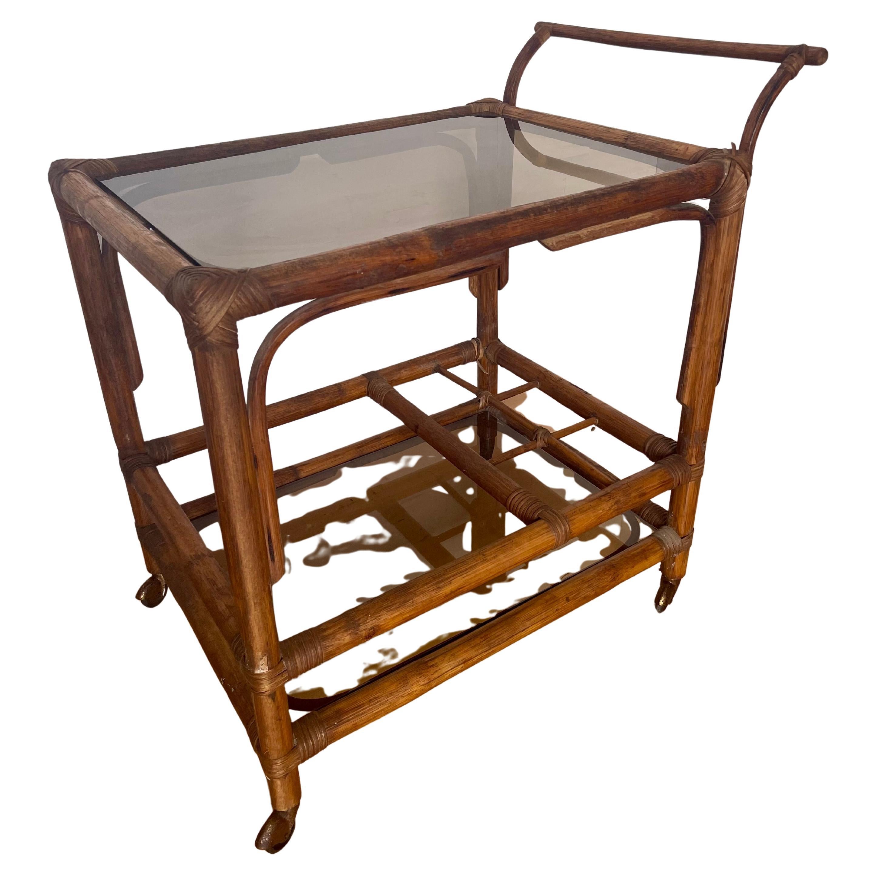 Carrello portavivande italiano in legno di bengala e vetro fumé anni '70