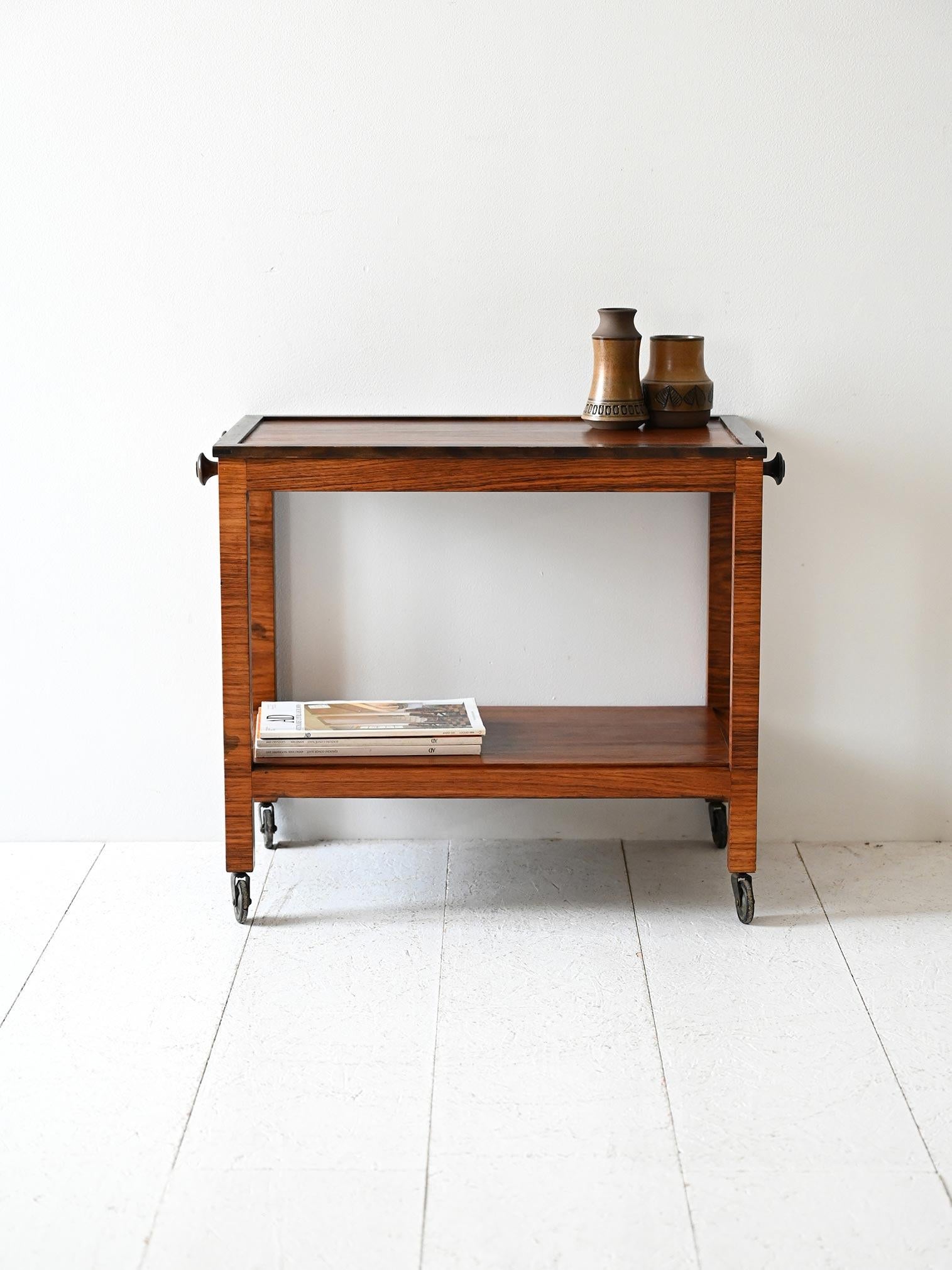 1930s trolley with casters, rosewood and birch root frame, with shelf for storage.

Vintage Scandinavian trolley dating from the 1930s, made of rosewood with birch root inserts. Equipped with four original casters and a lower shelf useful for