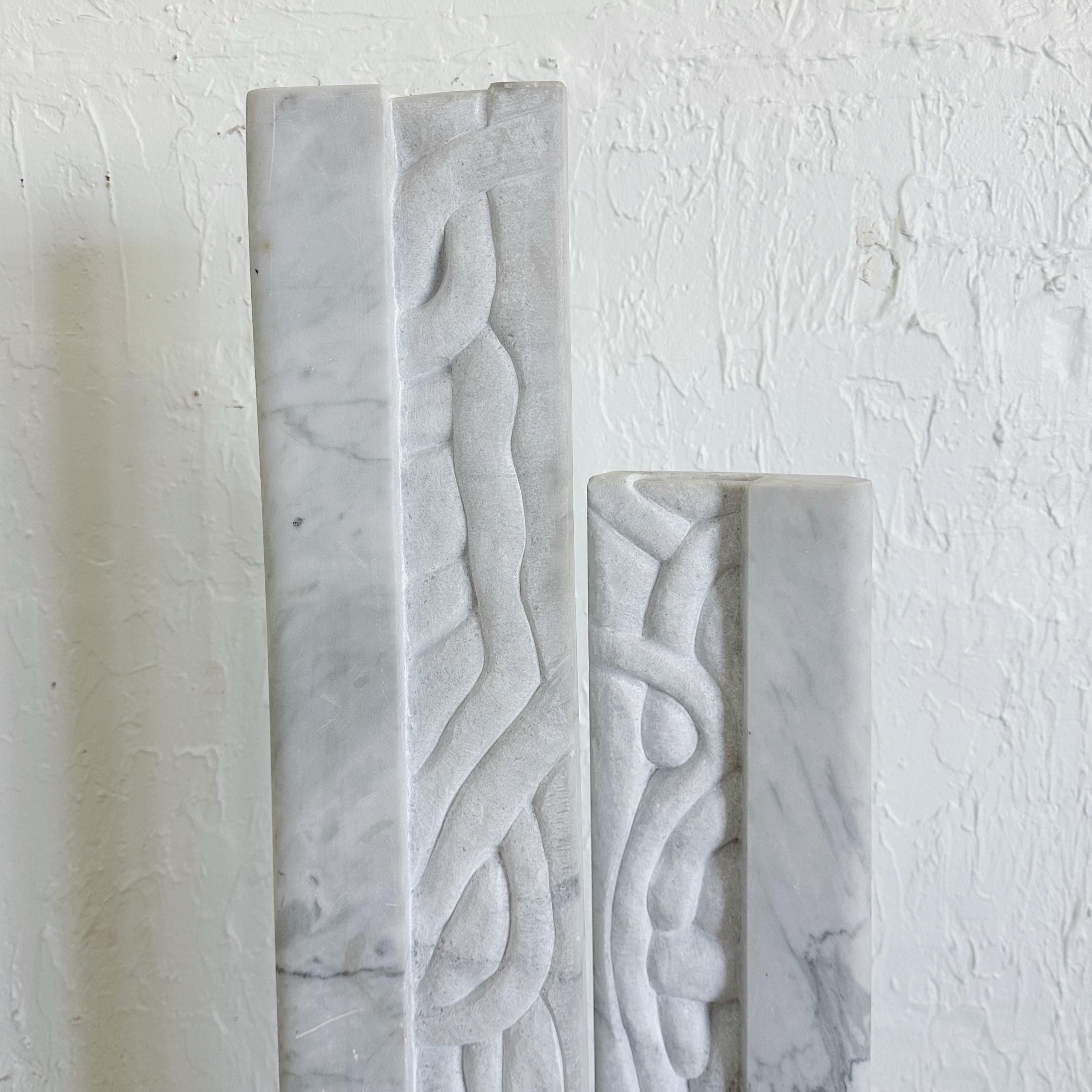 Carrara marble double column abstract sculpture. Carved abstract detail and geometric forms. Columns slide onto rods on a marble base. Unknown artist. Signed B. 88.