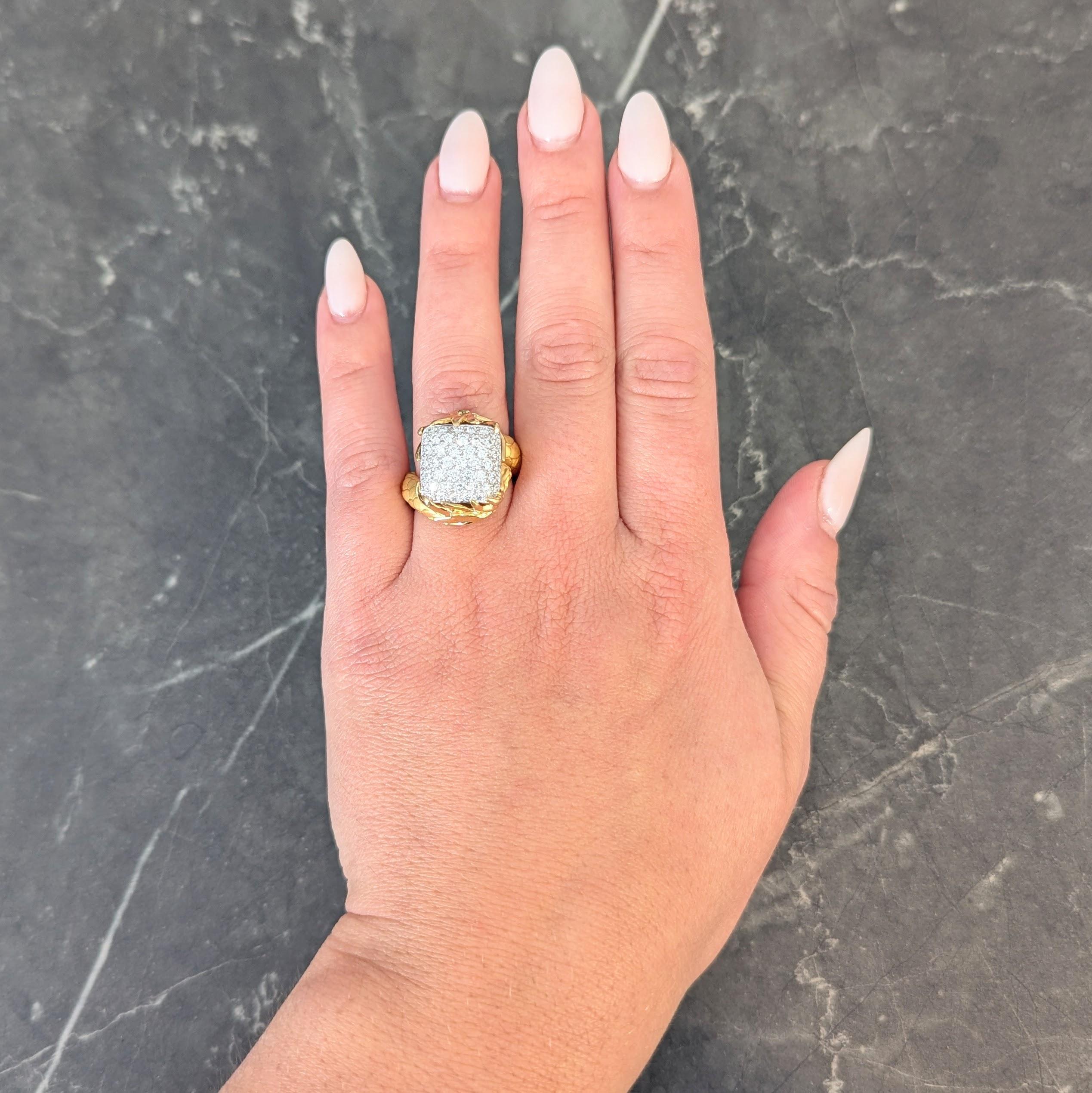 Centering a domed white gold cushion form pavé set throughout with round brilliant cut diamonds
Weighing approximately 1.25 carats total - G/H color with VS2 clarity
Flanked by yellow gold bypass style shoulders highly rendered as a
