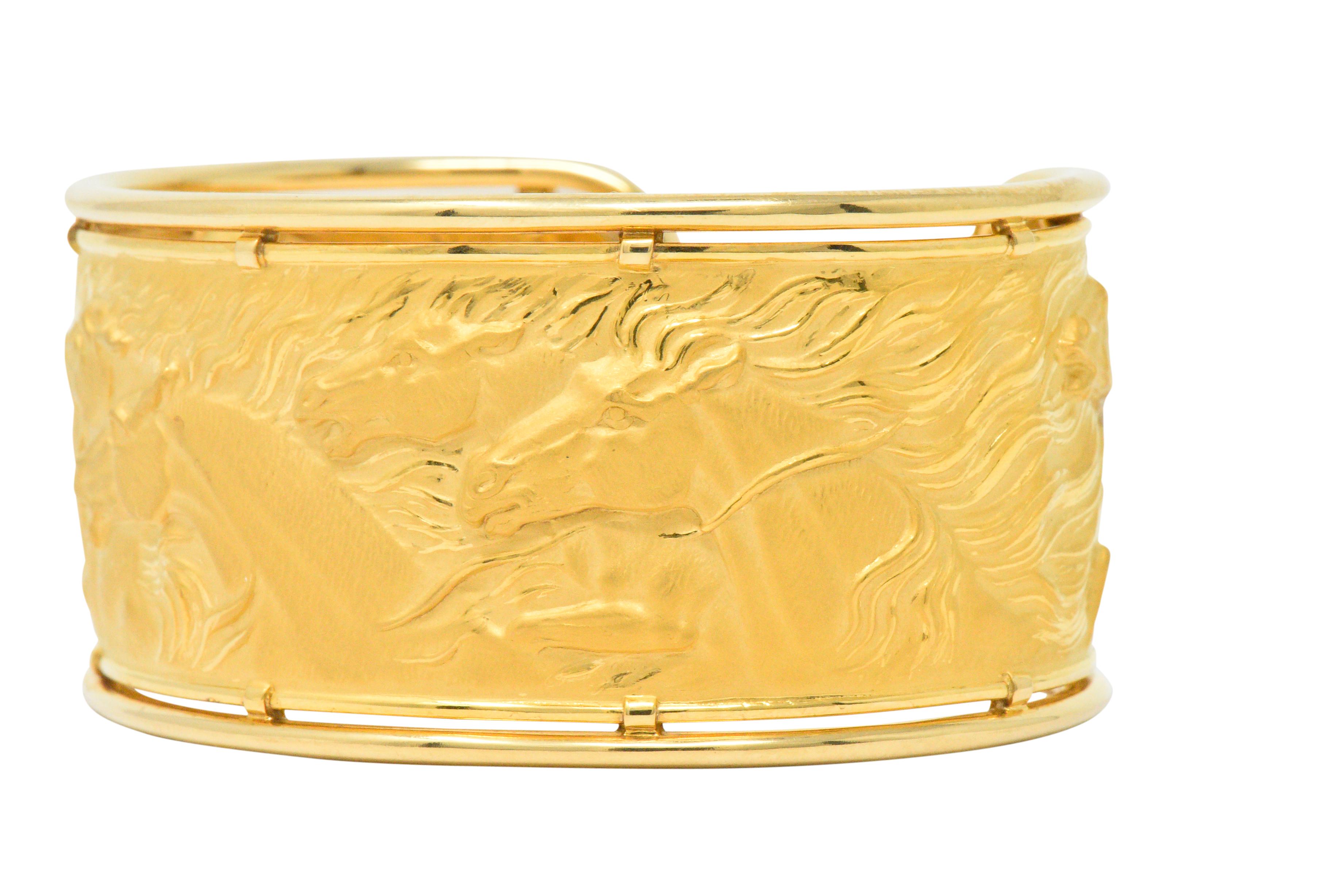 Cuff style bracelet with repoussé matte gold depicting a herd of galloping horses

With polished gold wire frame

Part of the Ecuestre collection

Maker's mark for Carrera y Carrera and numbered

Inner Length: 6 Inches

Width: Approx. 1 1/4