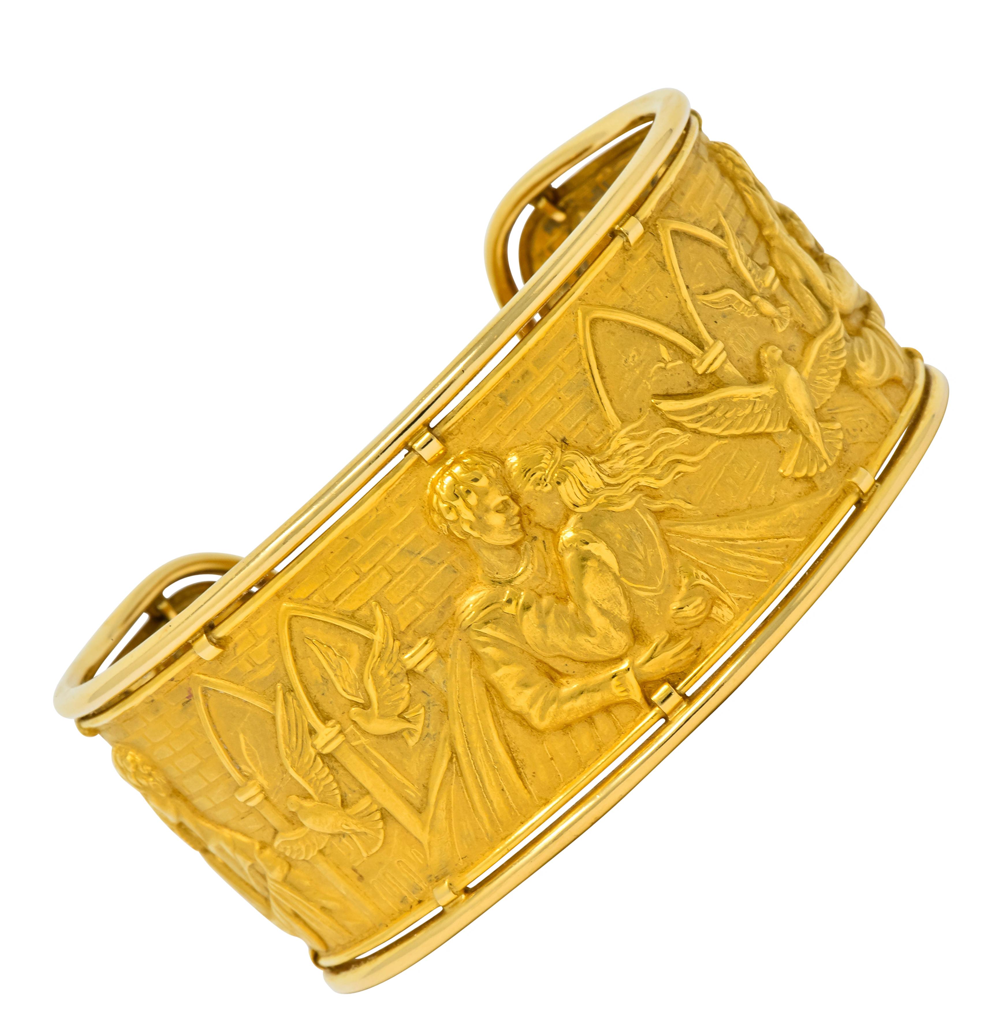 Repoussé style cuff bracelet depicting three heartwarming scenes of Romeo & Juliet embracing

Matte gold background is a highly rendered image of the medieval Italian city of Verona accented by soaring birds and brick motif

Surrounded by polished