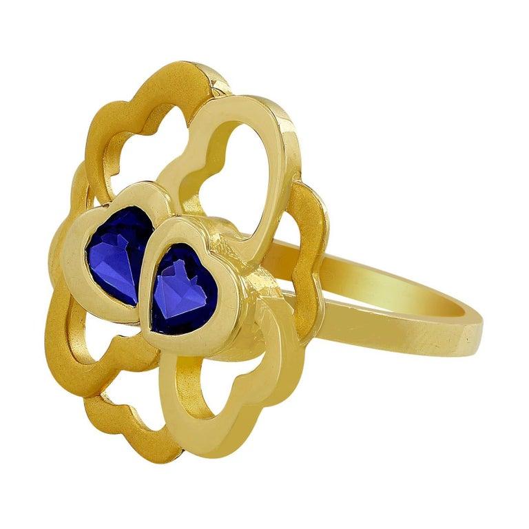 Carrera Y Carrera 18kt Yellow Gold Flower Iolite Ring. Two heart shaped Iolites are at the center of this whimsical high polish and brush finish 18kt yellow gold flower ring.