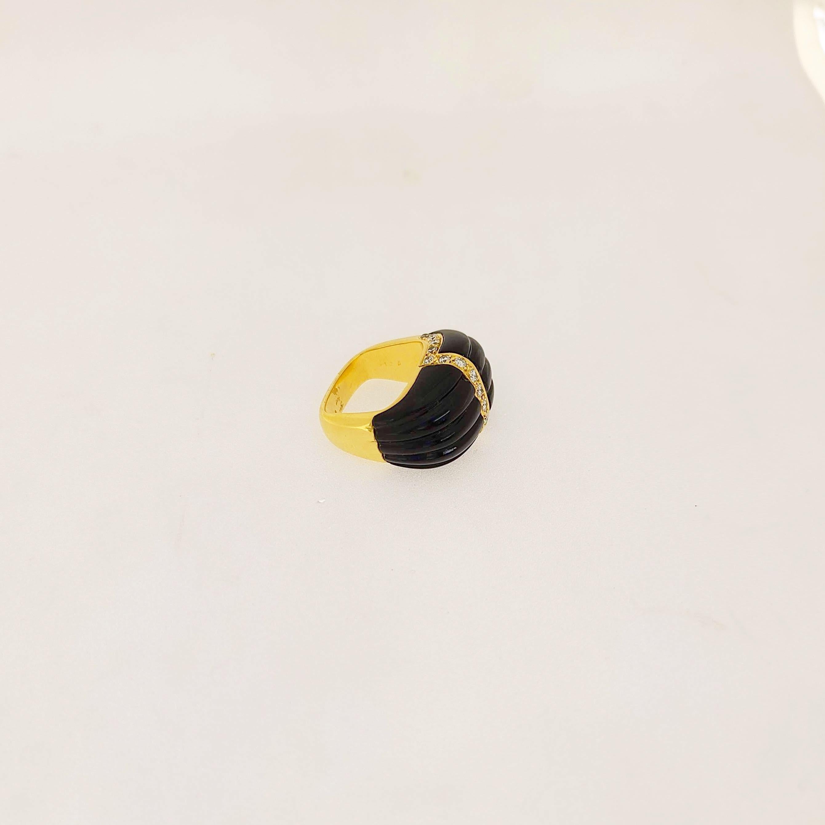 Vintage Carrera Y Carrera 18 karat yellow gold cocktail ring. The squarish domed shaped ring is set with ribbed black onyx and accented with round brilliant diamonds. This unique ring has a square shank.
Total Diamond weight 0.47 carats
Ring size, 5