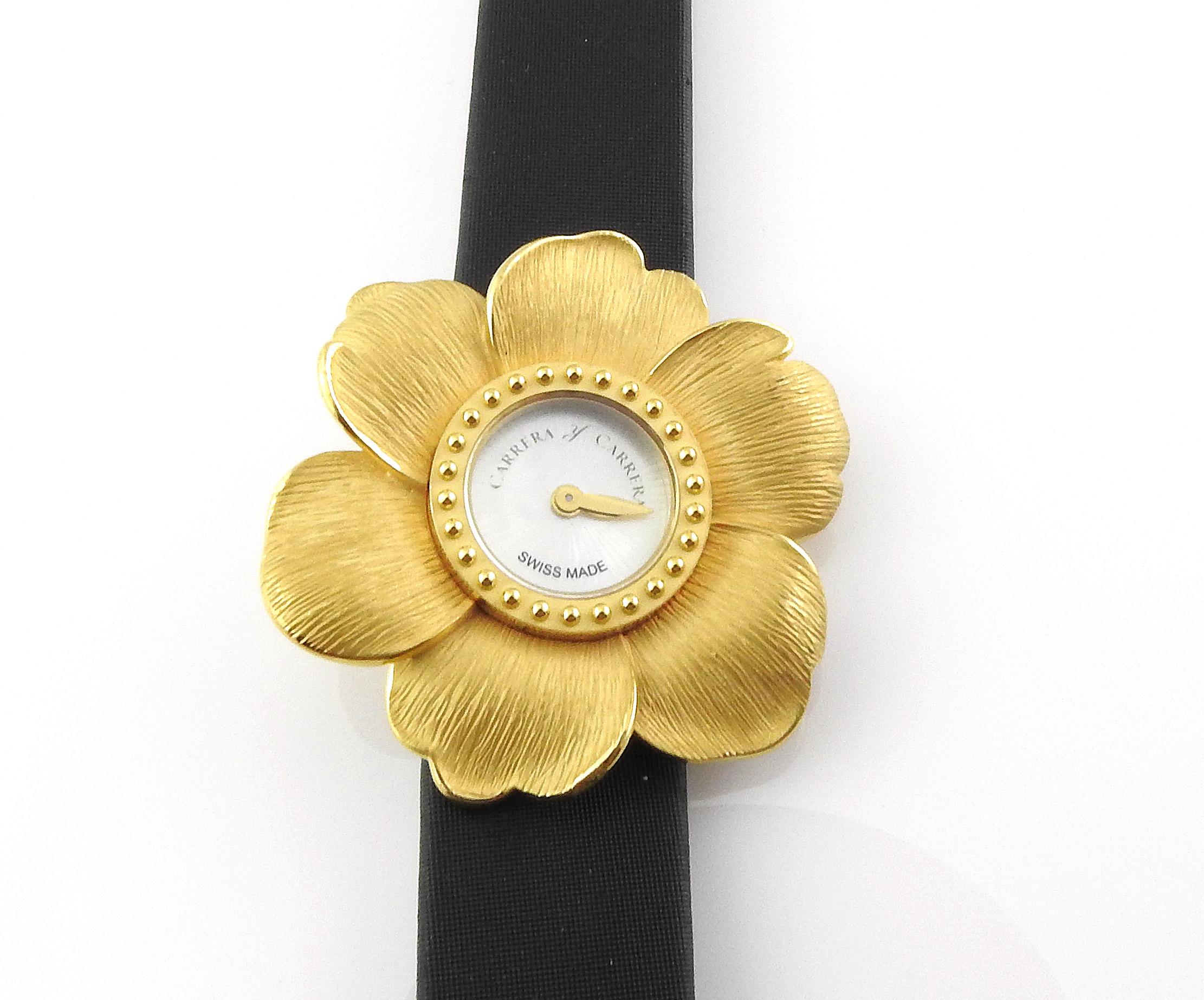 Carrera Y Carrera 18K Yellow Gold Ladies Gardenia Watch

Model 1000-00218

Case is approx. 37.5 mm in diameter

18K Yellow Gold Case and Buckle

Black Satin Band  - some wear to the band as shown in pictures

Guilloche Mother of Pearl Dial

Quartz