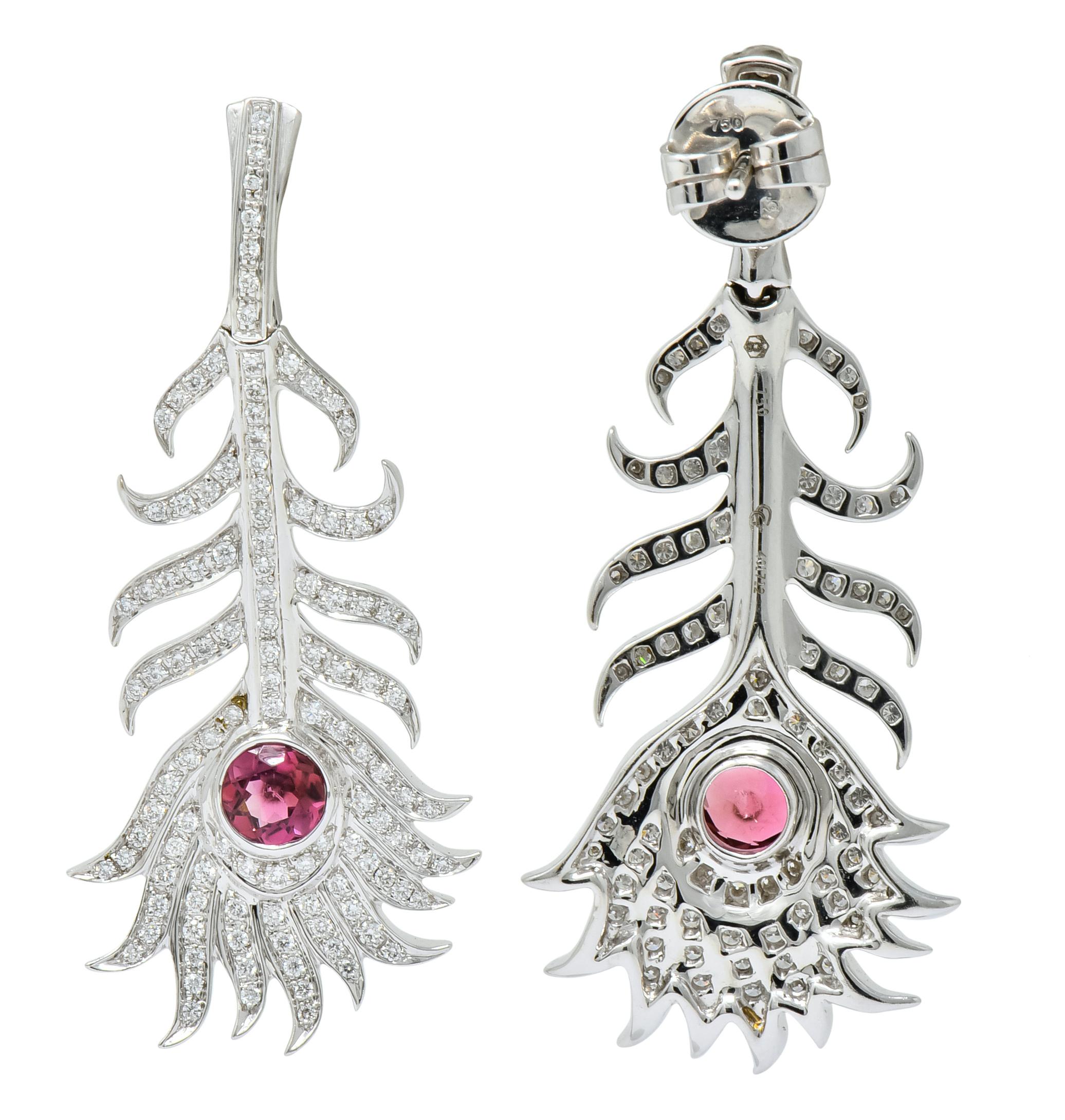 Each designed as a peacock feather with pavé set round brilliant cut diamonds weighing approximately 1.80 carats total, E-F color and VS clarity

Accented by bezel set tourmaline, deep bubble gum in color, weighing approximately 1.25 carats