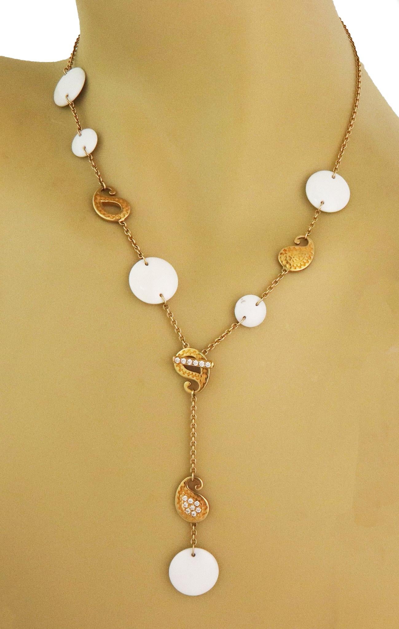 From the Aqua Collection by Carrera y Carrera, this lovely authentic necklace is crafted from 18k yellow gold featuring flat button shape small and large white agate beads attached to a sturdy oval link chain with paisley open and solid motifs set