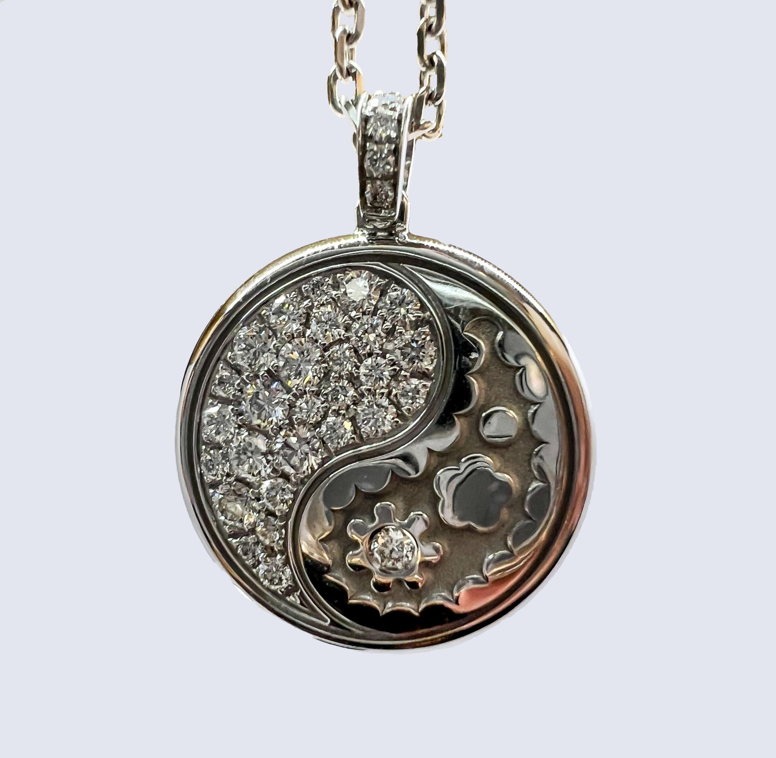 18K White Gold pendant. 18K White Gold cable chain with lobster claw lock. This pedant is reversible. Both sides are decorated as Yin Yang symbol. One side is decorated with White Diamonds and other side is decorated with Black Diamonds. All